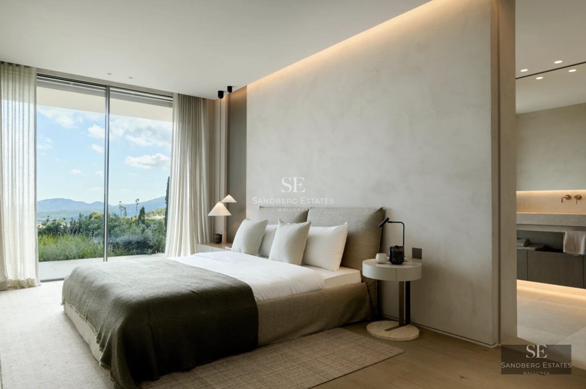 Spacious living room with balcony and views. Modern design, wood floors, natural lighting, and elegant furniture. Bright and welcoming space.