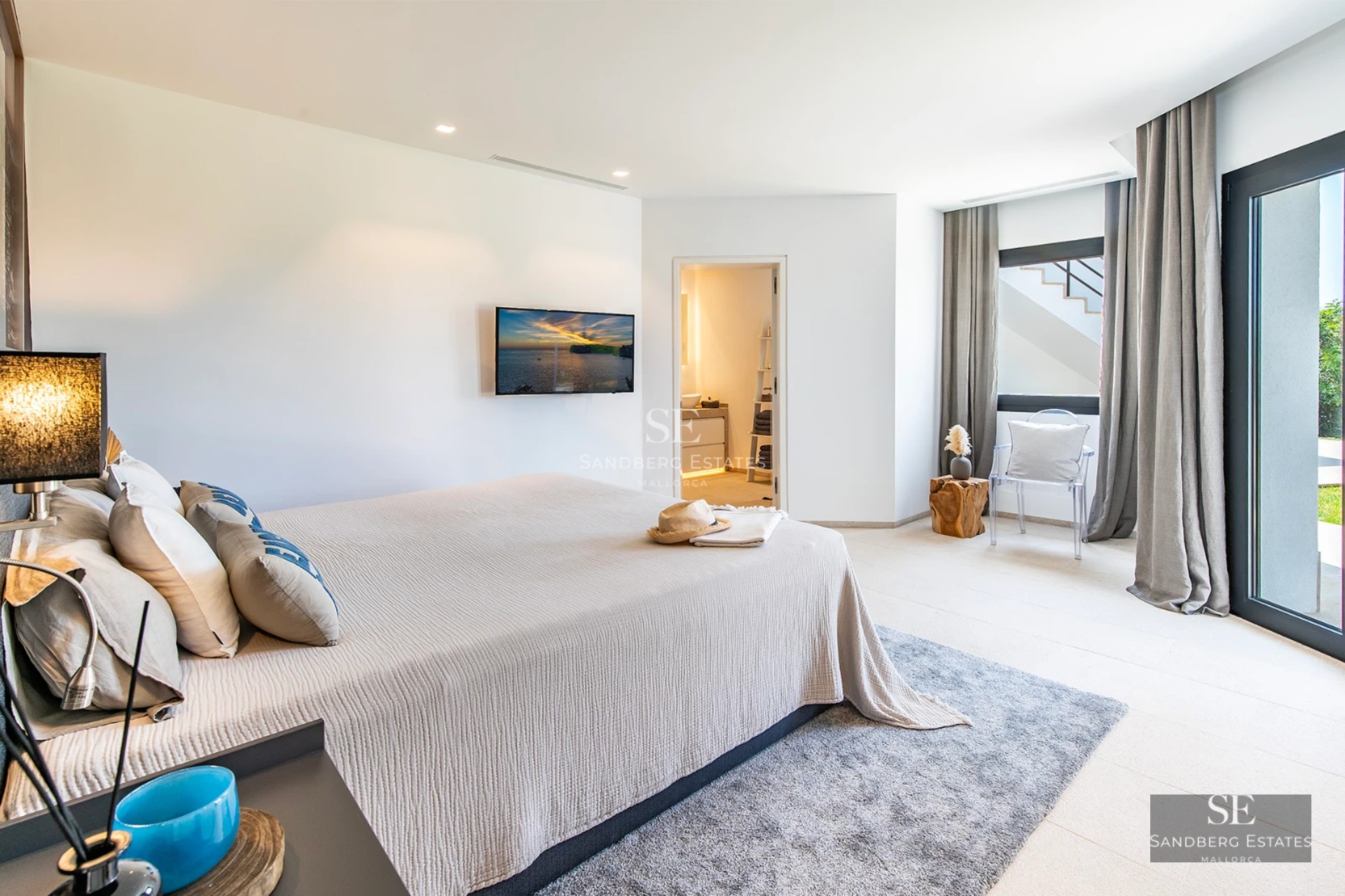 Spacious balcony with sea view, modern furniture, glass railing, wooden floor, perfect for enjoying the outdoors.