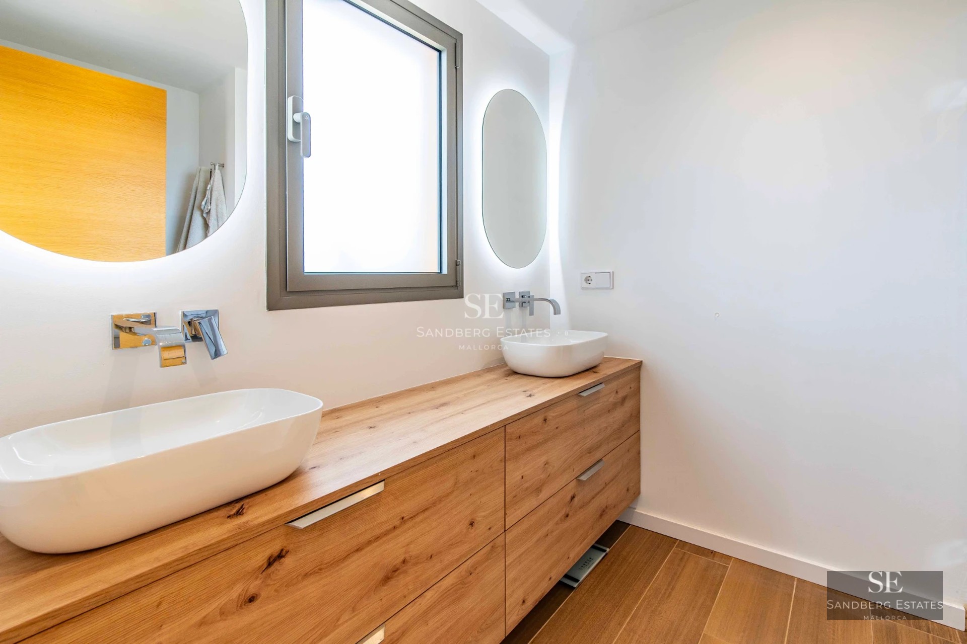 Exterior view of a modern villa featuring a pool, large windows, lush garden, and high-quality finishes.