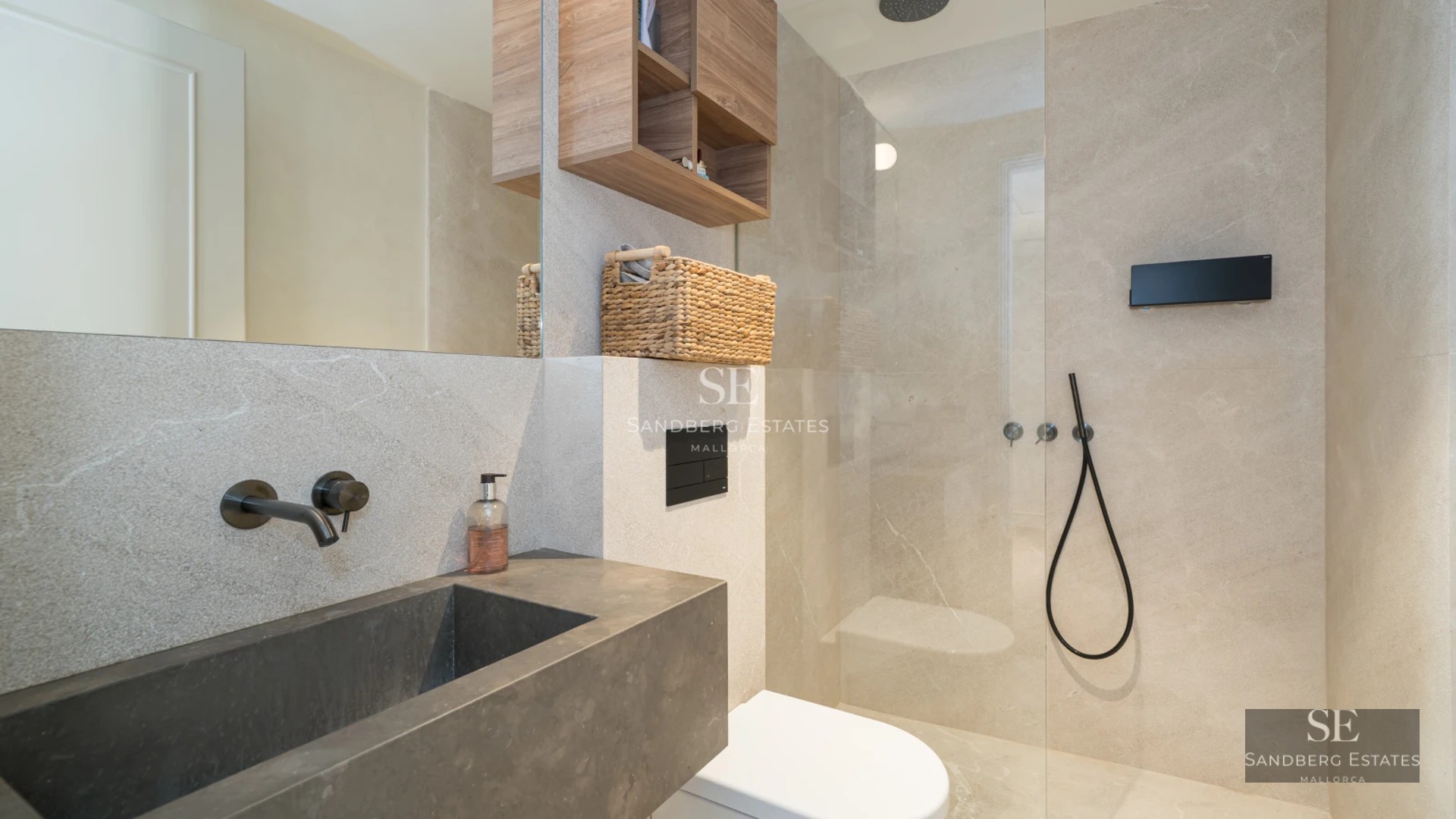 Aerial view of a modern villa with an infinity pool, surrounded by lush greenery and featuring spacious terraces.