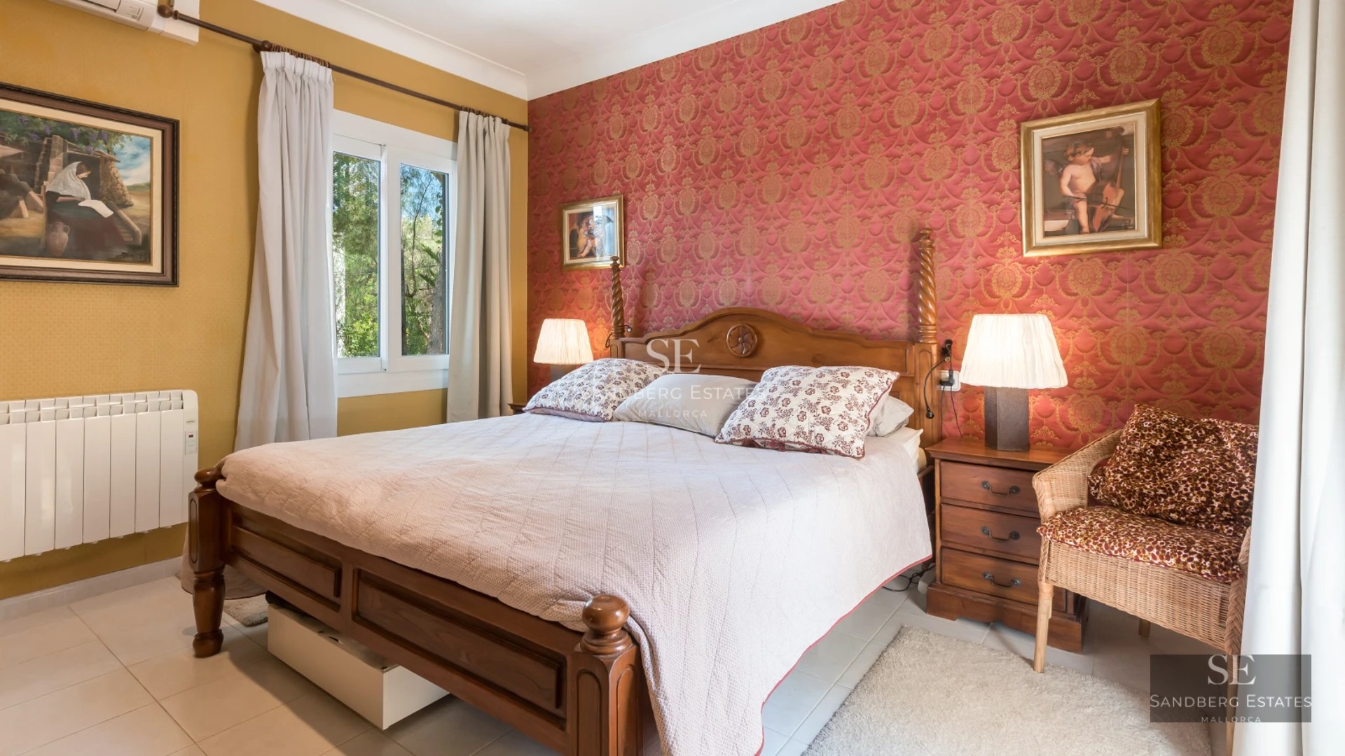 Spacious living room with fireplace, large windows, and designer furniture. Natural light and access to a terrace with panoramic views.