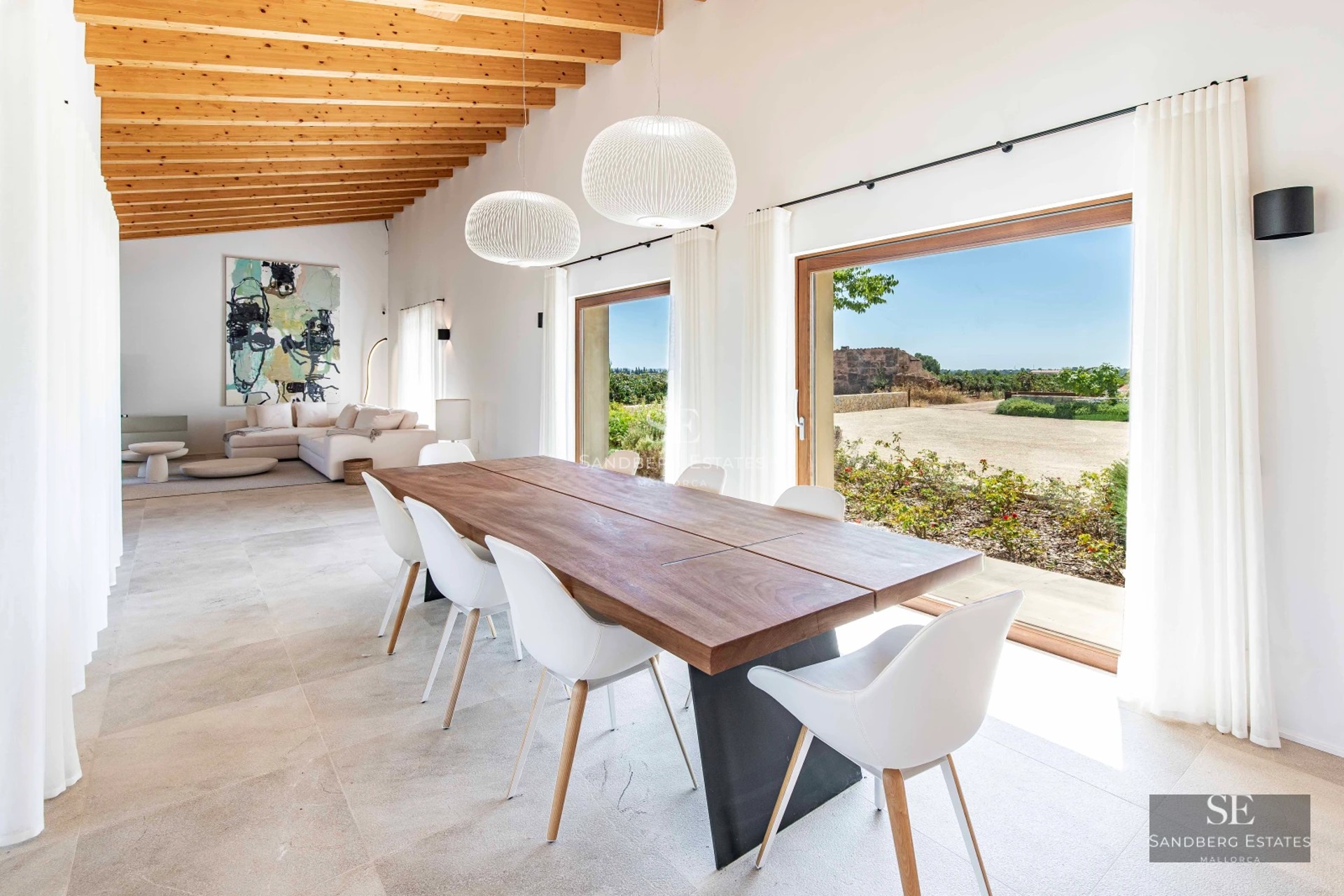 View of a modern villa with infinity pool and garden. Minimalist architecture with large windows. Palm trees and outdoor furniture.