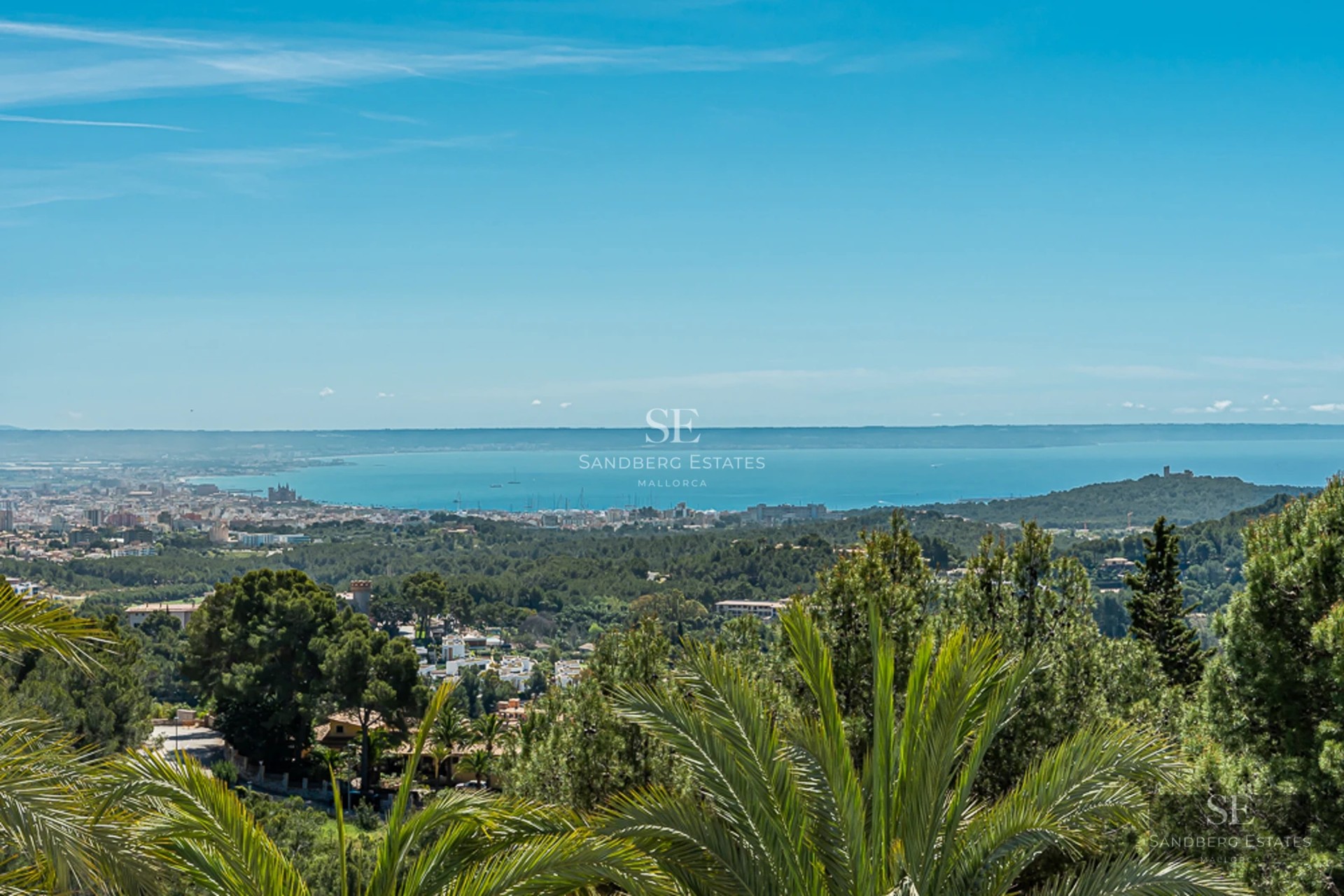 Bright living room with large windows, designer furniture, and panoramic sea views. Beige sofa, elegant coffee table, and modern decor.