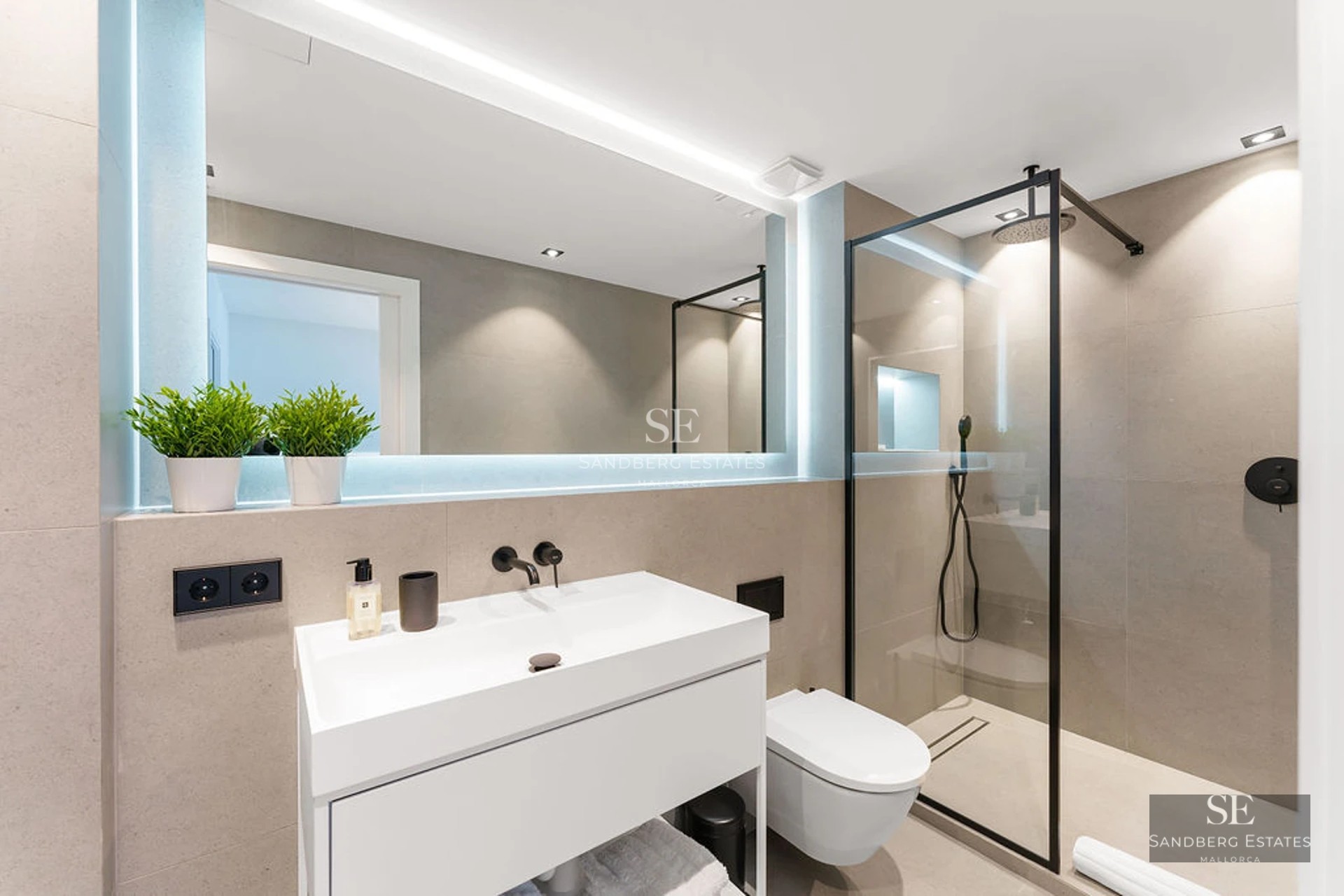 Spacious living room featuring panoramic windows, light wood floors, modern furniture, and minimalist decor. Breathtaking sea views.