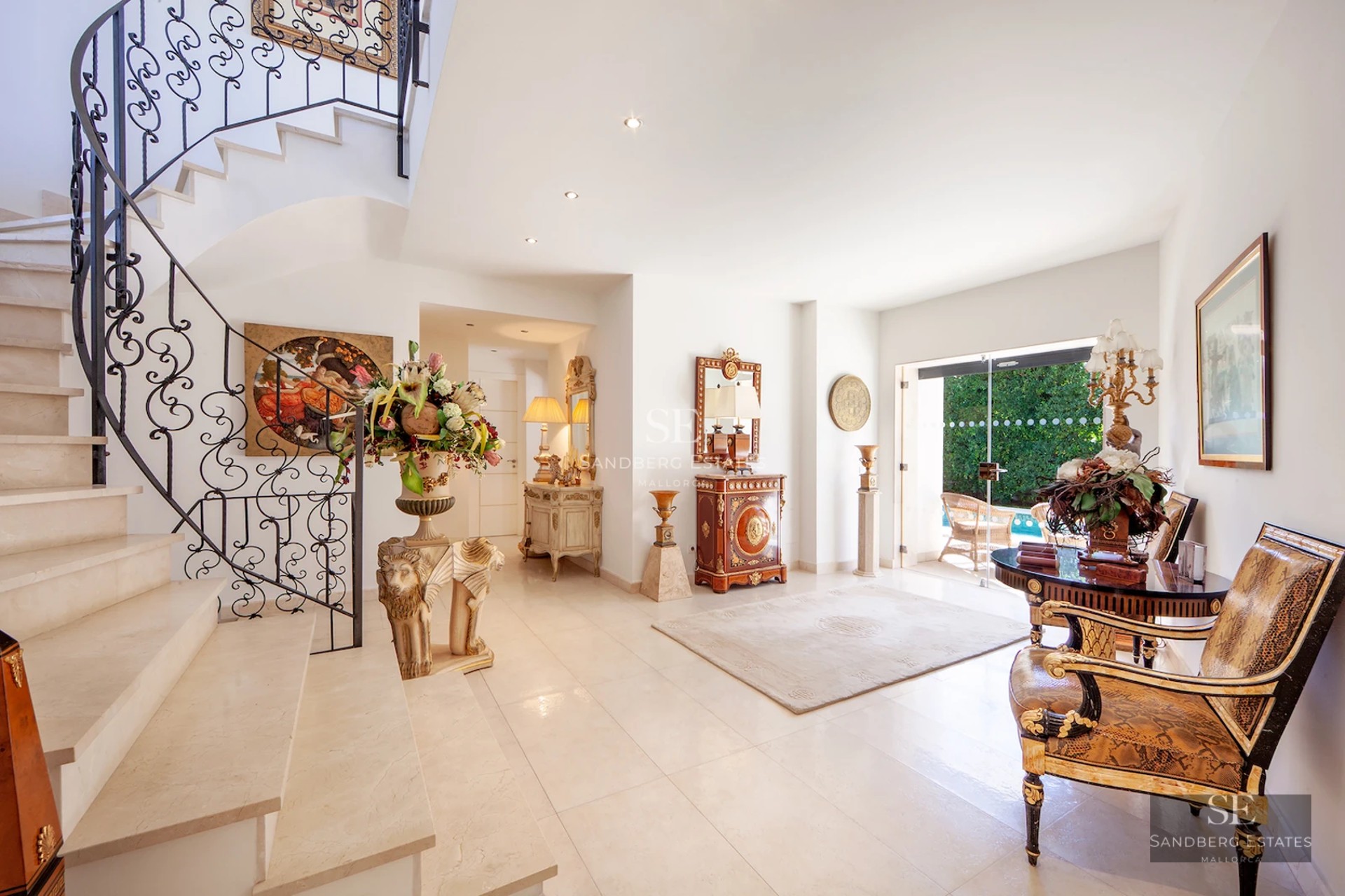 Spacious living room featuring an infinity pool and ocean views. Modern design, large windows, light tile floors, and minimalist furniture.