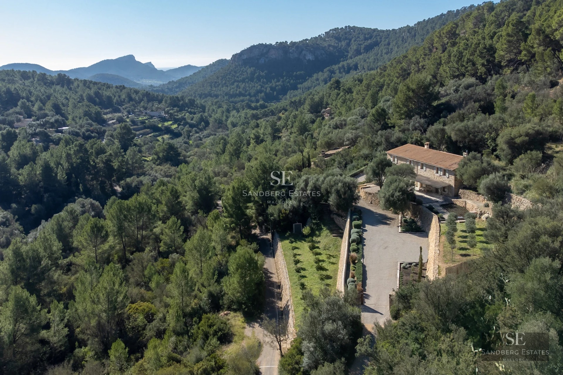 Exterior view of a luxury villa with a pool, manicured garden, and modern architecture. Minimalist design and large window panes.
