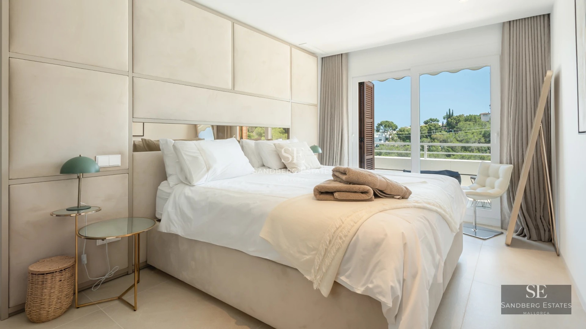 Aerial view of a luxurious villa with infinity pool, landscaped garden, and minimalist modern architecture. Clear blue sky.