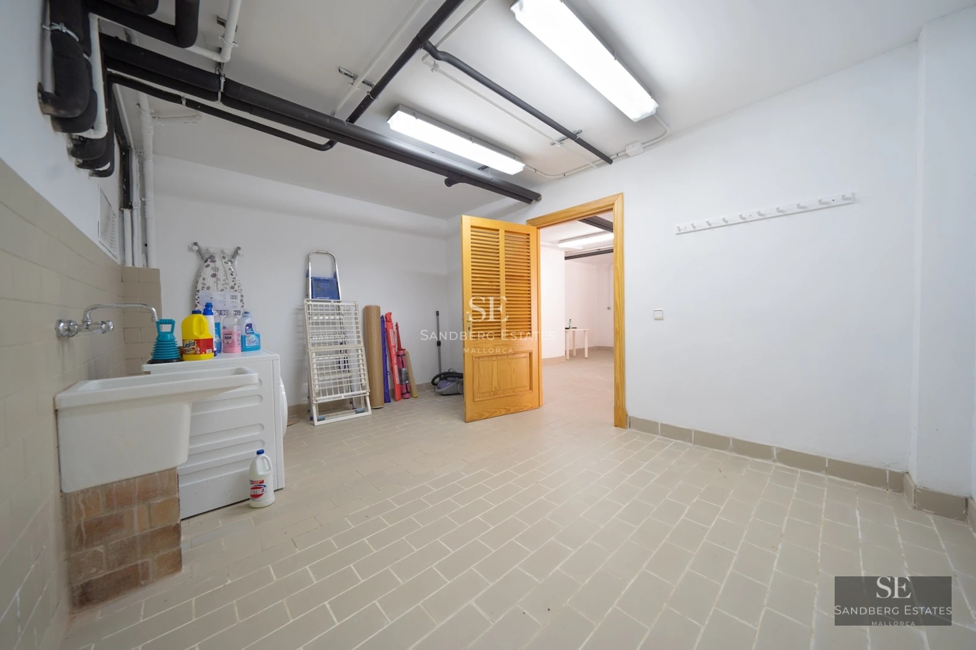 Expansive terrace with infinity pool and sea views. Modern architecture, sun loungers, and lush greenery.