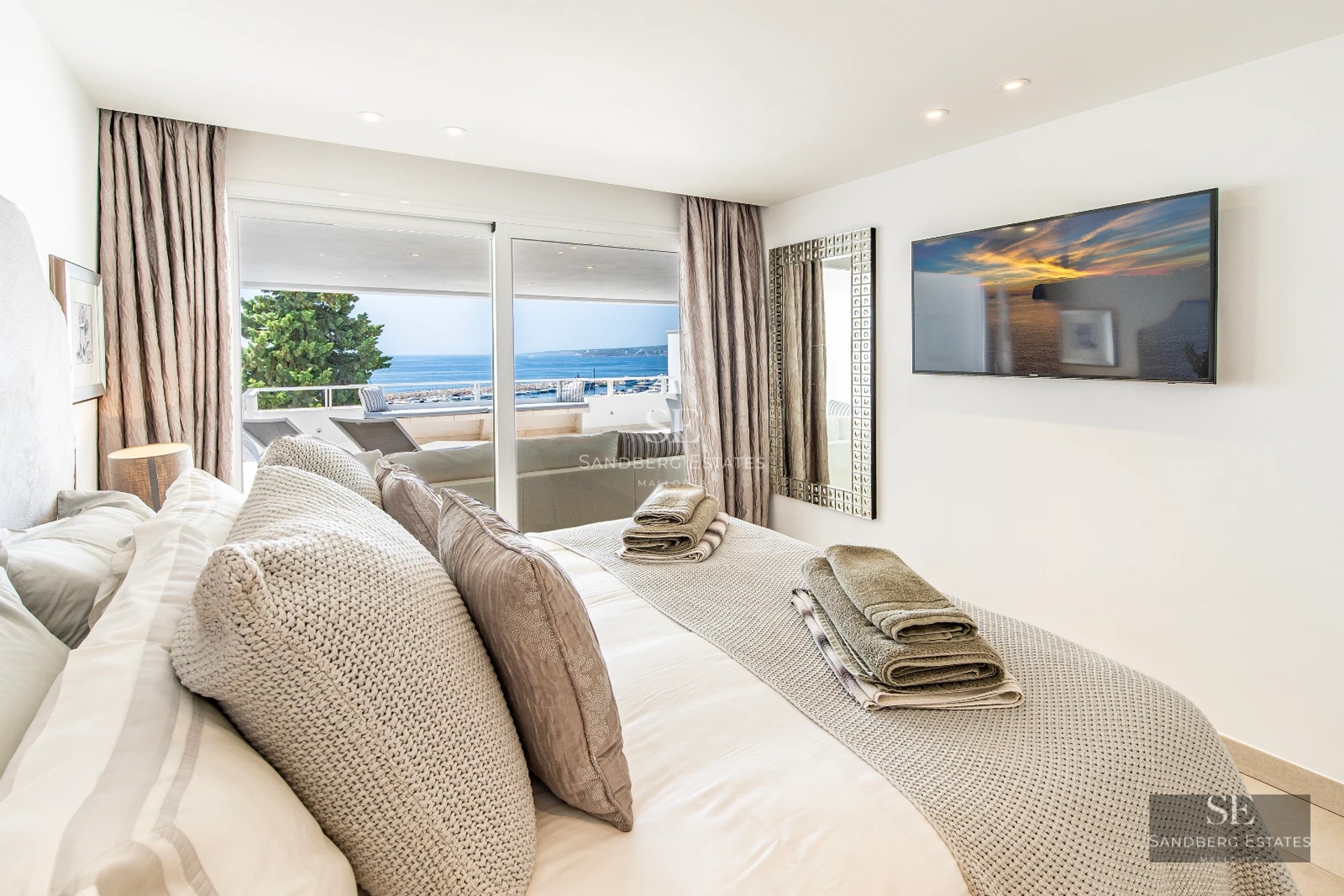 Exterior view of modern villa with pool, garden, and terrace. Large windows illuminate the architectural design. Impeccable landscaping.