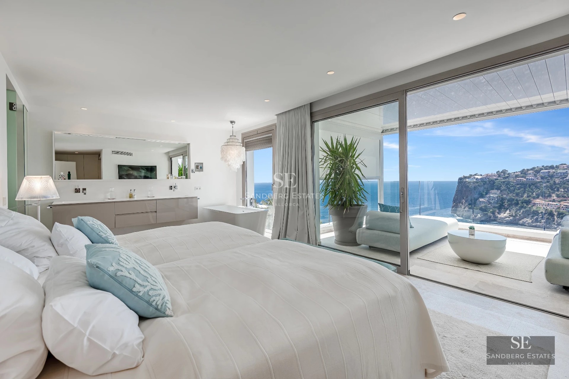 Spacious terrace with infinity pool and sea views. Modern design, glass railing and elegant furniture.