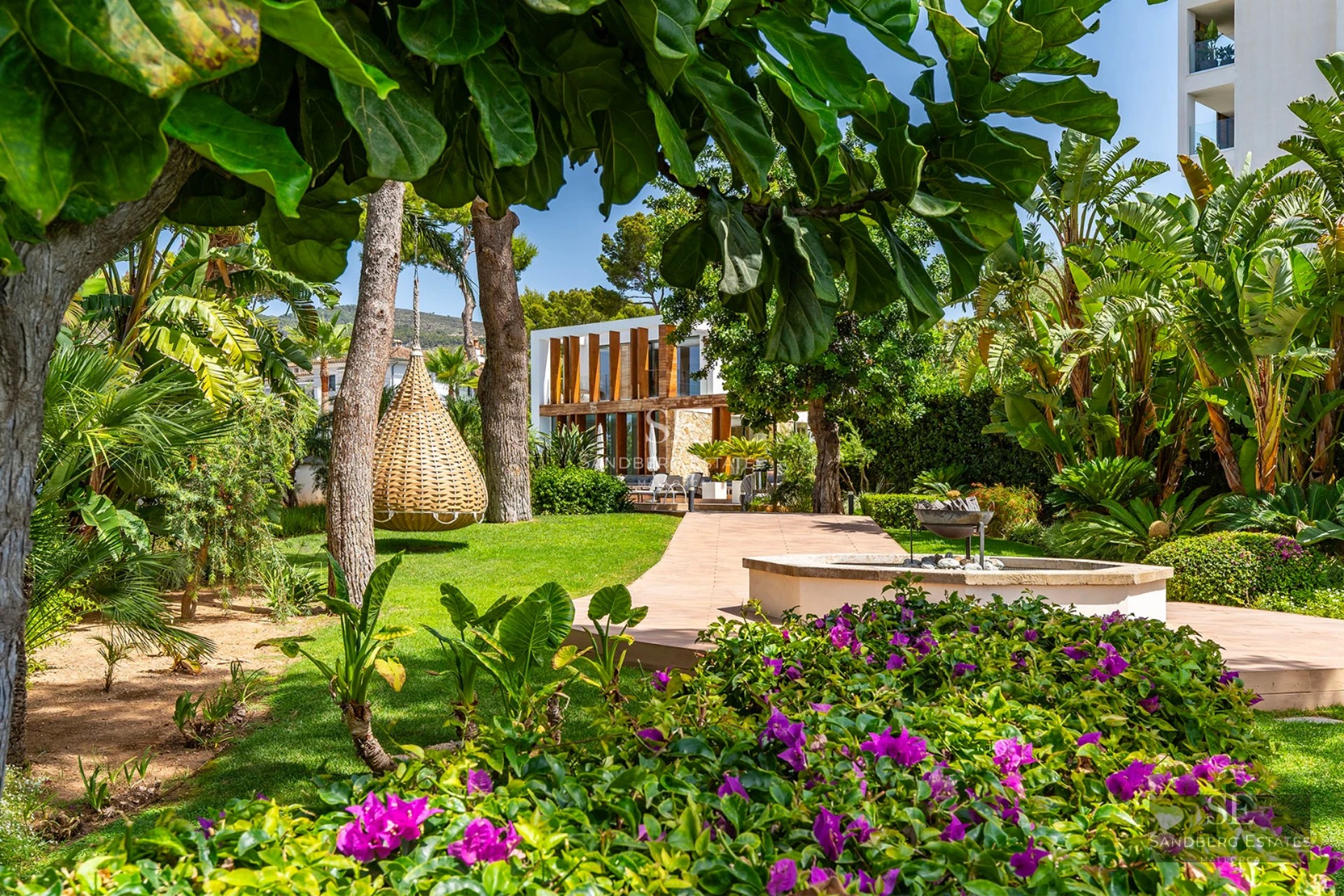 Spacious balcony with glass railing, panoramic views, outdoor furniture. Modern and elegant design with ambient lighting.