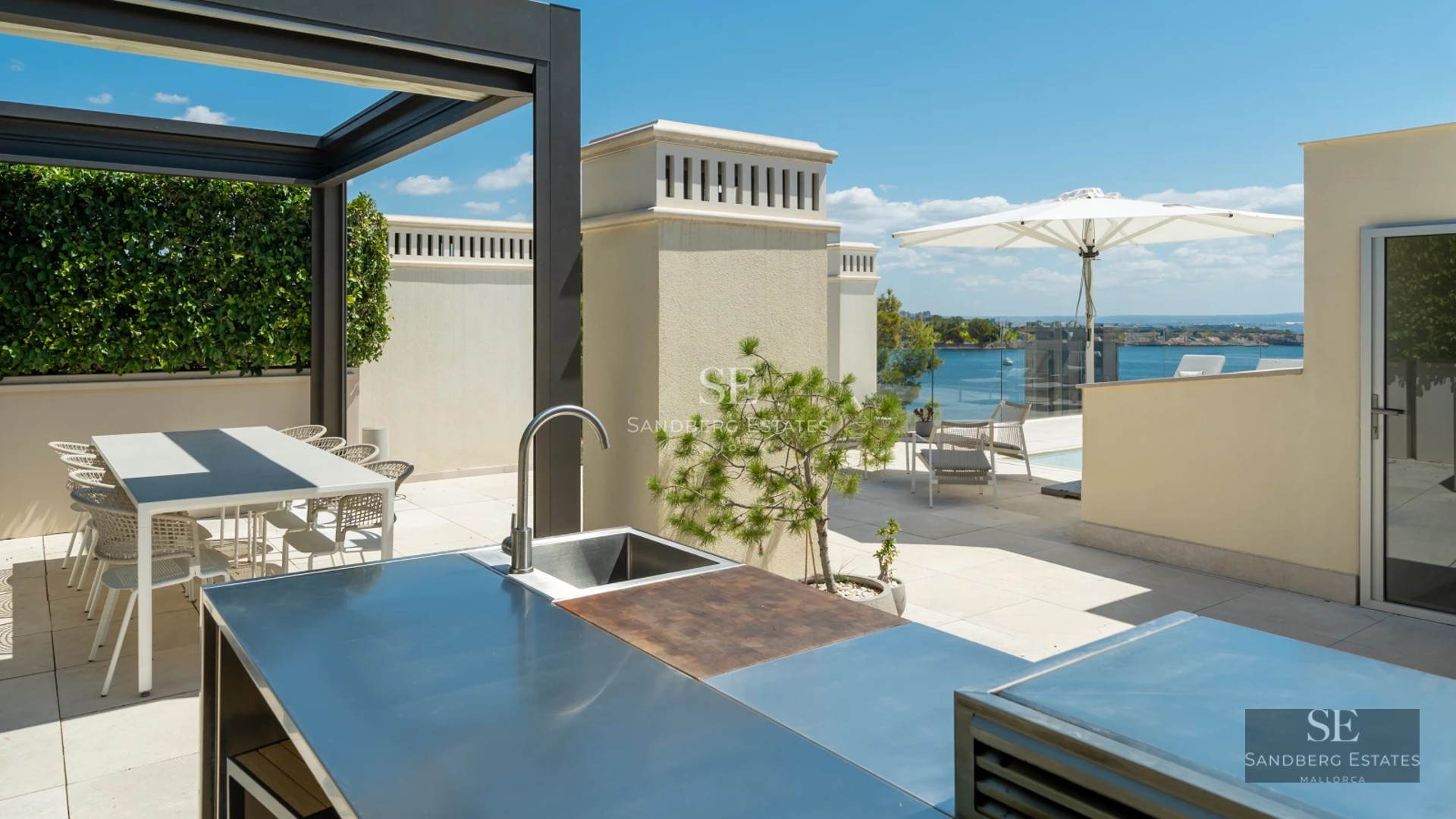 Exterior view of a modern villa featuring an infinity pool, lush garden, and contemporary architecture. Warm sunset lighting.