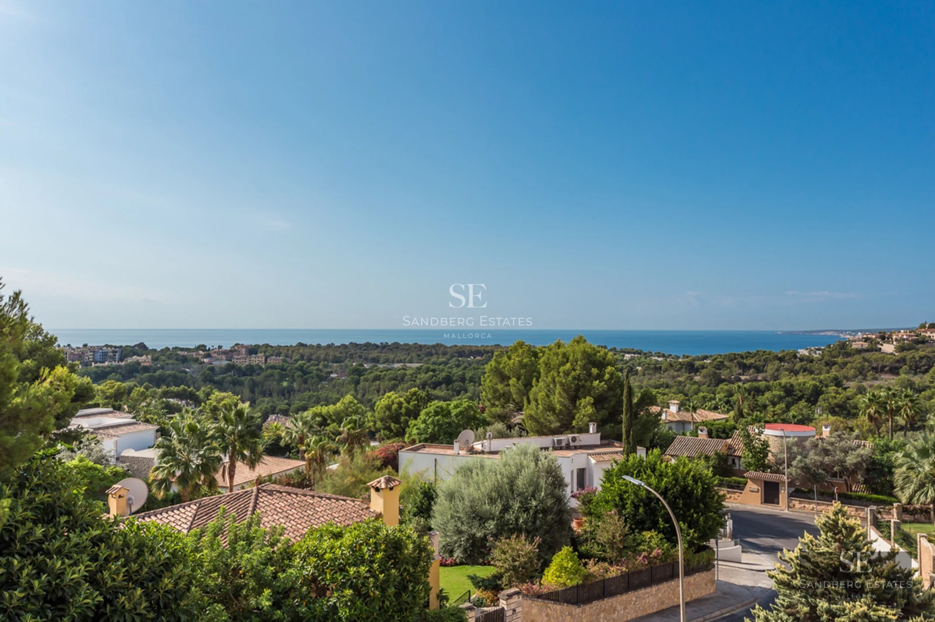 Spacious living room with floor-to-ceiling windows overlooking the sea, modern furniture, natural light, and neutral color palette. Sleek, minimalist design.
