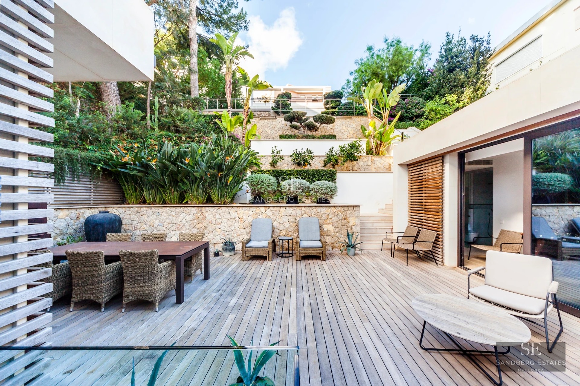 Spacious living room with floor-to-ceiling windows, sea view, modern design, natural light, and high-end furniture. Ideal real estate investment.