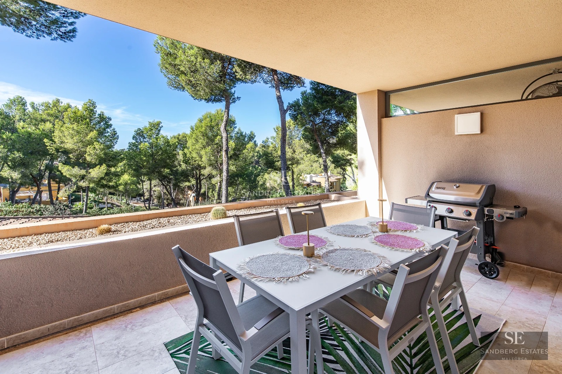 Panoramic view of a luxurious property featuring a pool, lush gardens, and modern design. Large windows illuminate the interior.