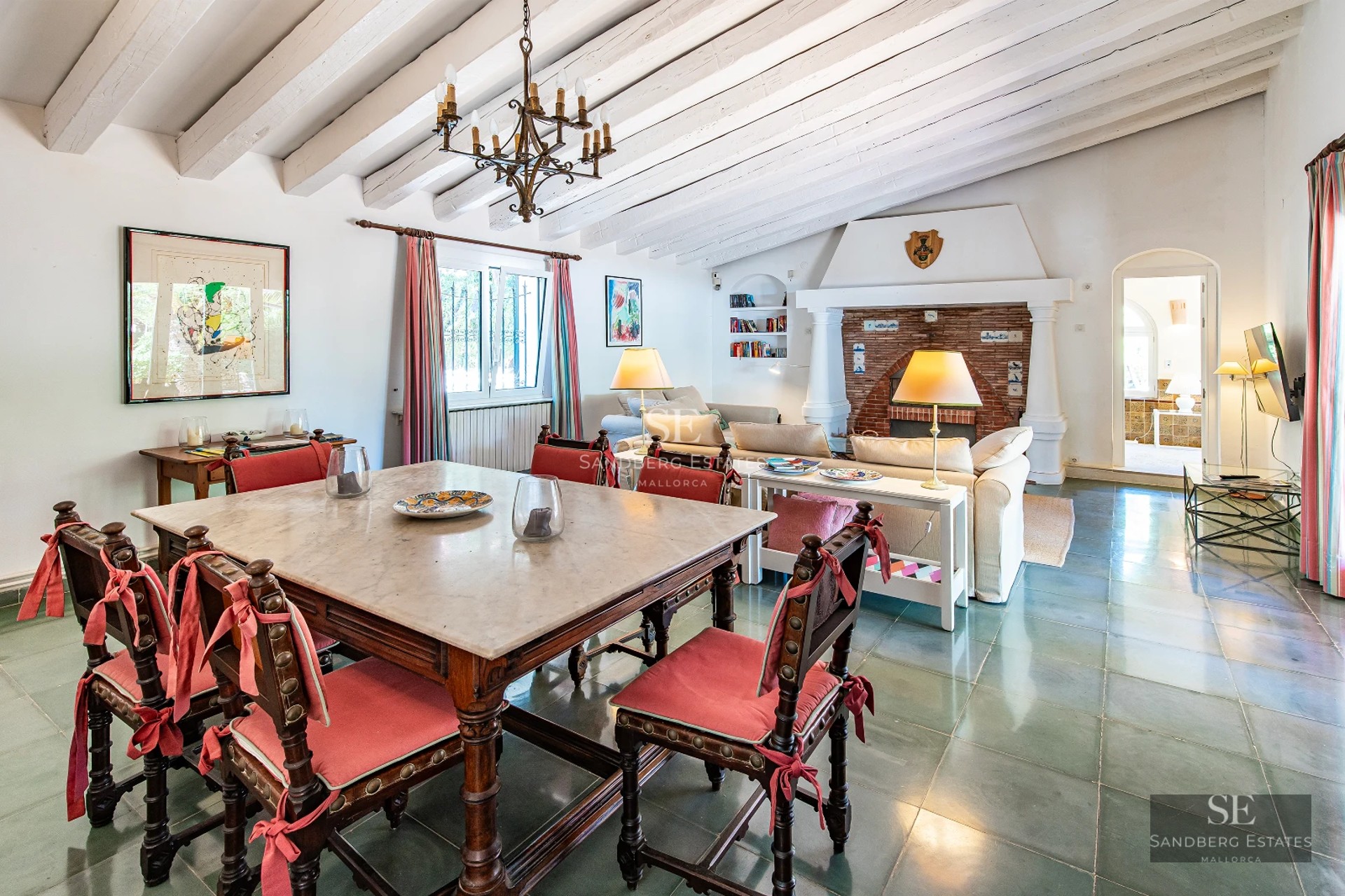 View of infinity pool with lush garden. Modern architecture with large windows and elegant landscaping design.