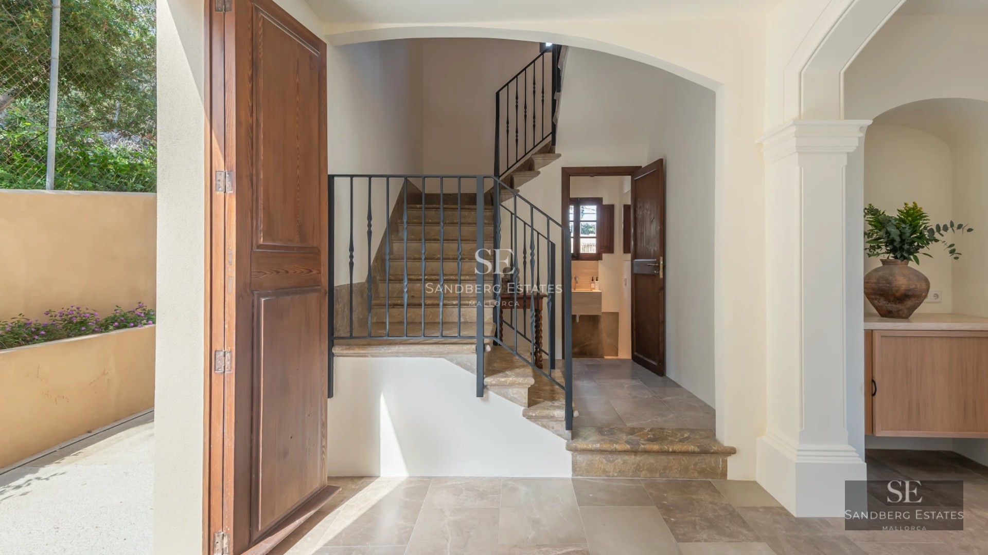 Aerial view of a modern villa with infinity pool, surrounded by lush gardens and overlooking the sea. Minimalist and elegant design.