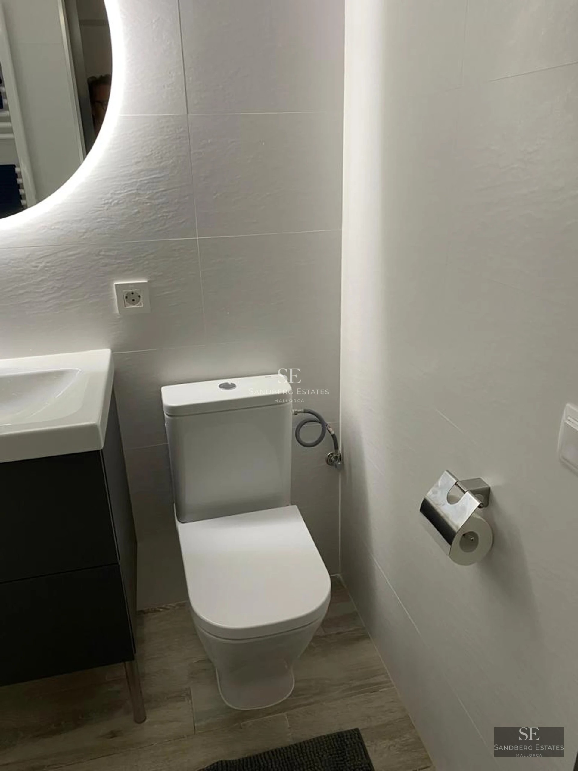 Exterior view of modern home with reflecting pool, lush garden and minimalist architecture. Soft lighting enhances the details.