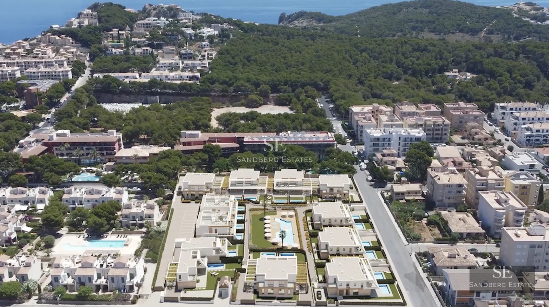 View of a modern villa featuring an infinity pool, expansive glass windows, and minimalist garden. Clean and elegant architectural design.