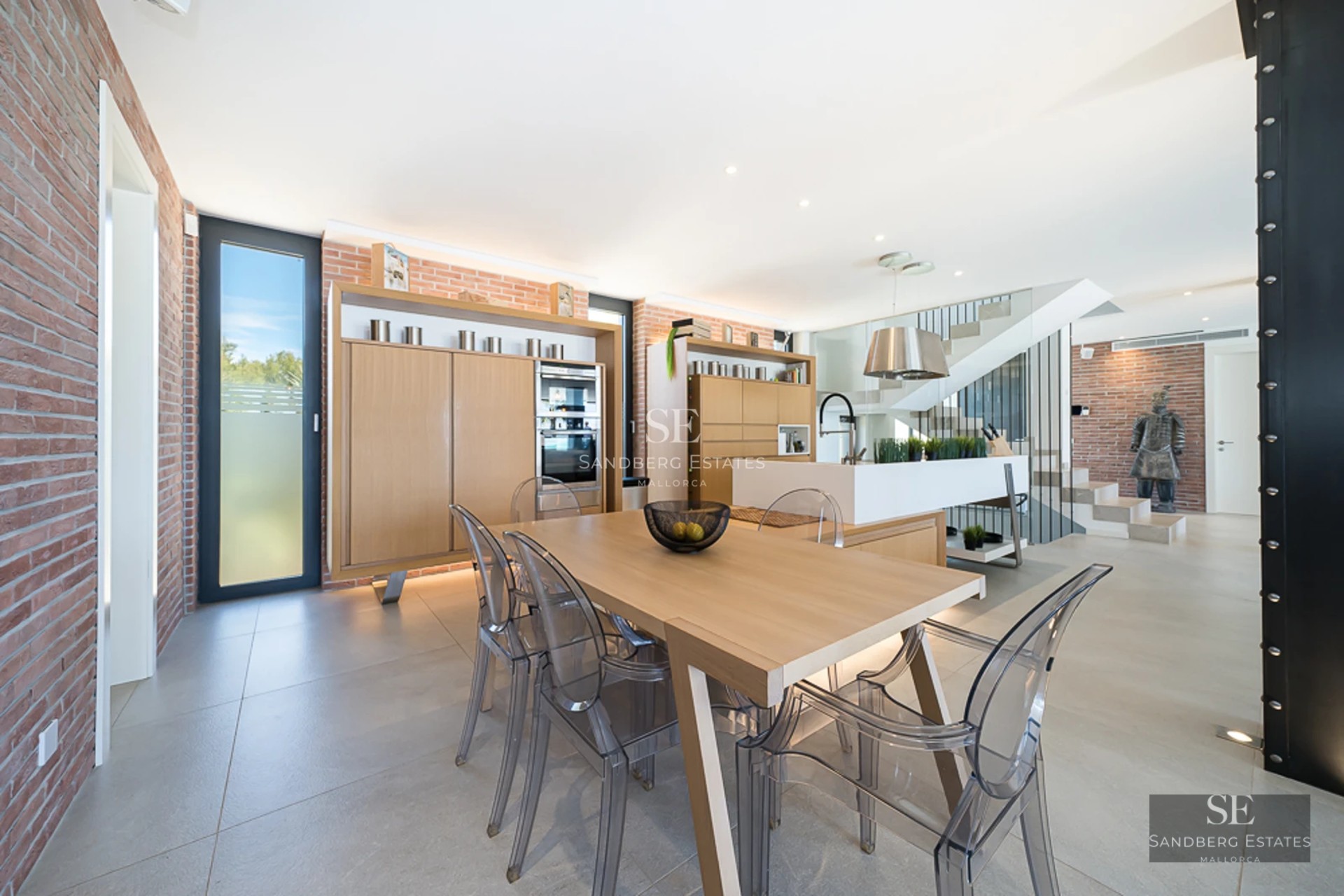 Panoramic view from a luxurious balcony with an infinity pool and sea views. Modern design with elegant furniture and lush vegetation.