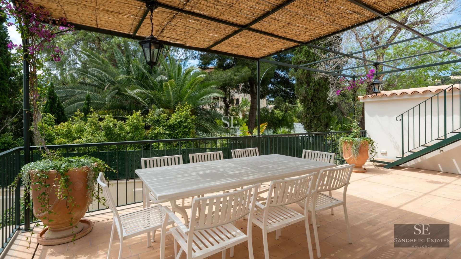 Spacious balcony with sea view. Glass railing, modern and elegant furniture. High-quality finishes and minimalist design.