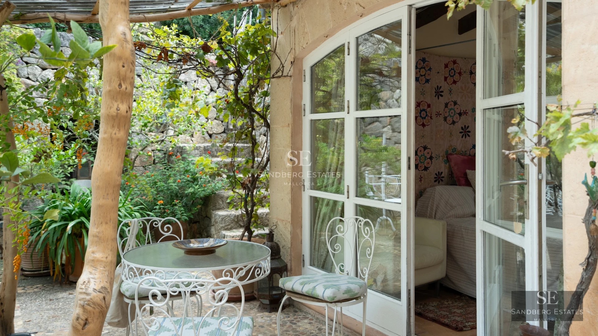 Spacious living room with pool access. Features include large windows, white sofas, and a modern design. Bright and welcoming space.