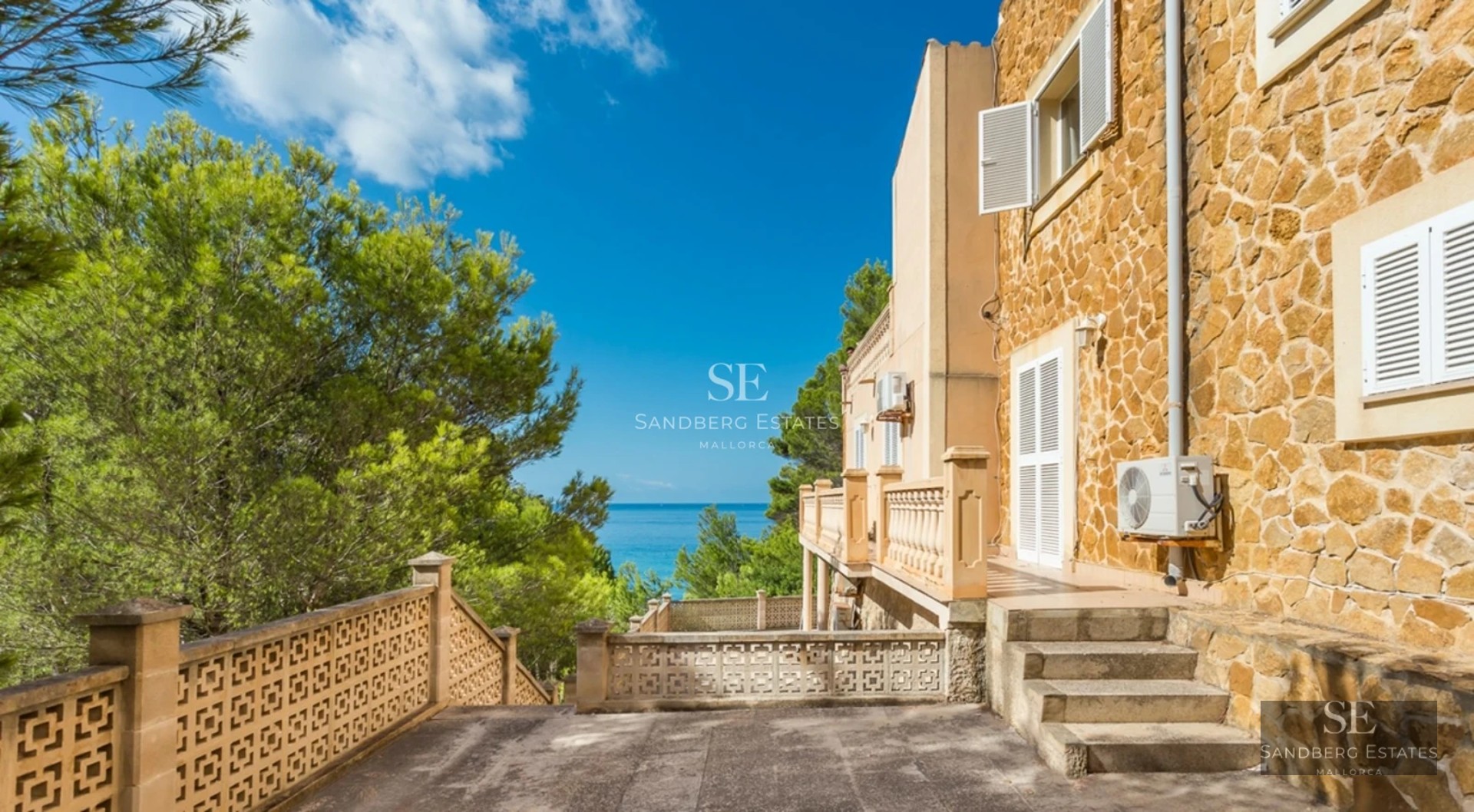 Aerial view of modern villa with infinity pool, lush garden, and minimalist architecture. Wood and stone detailing.