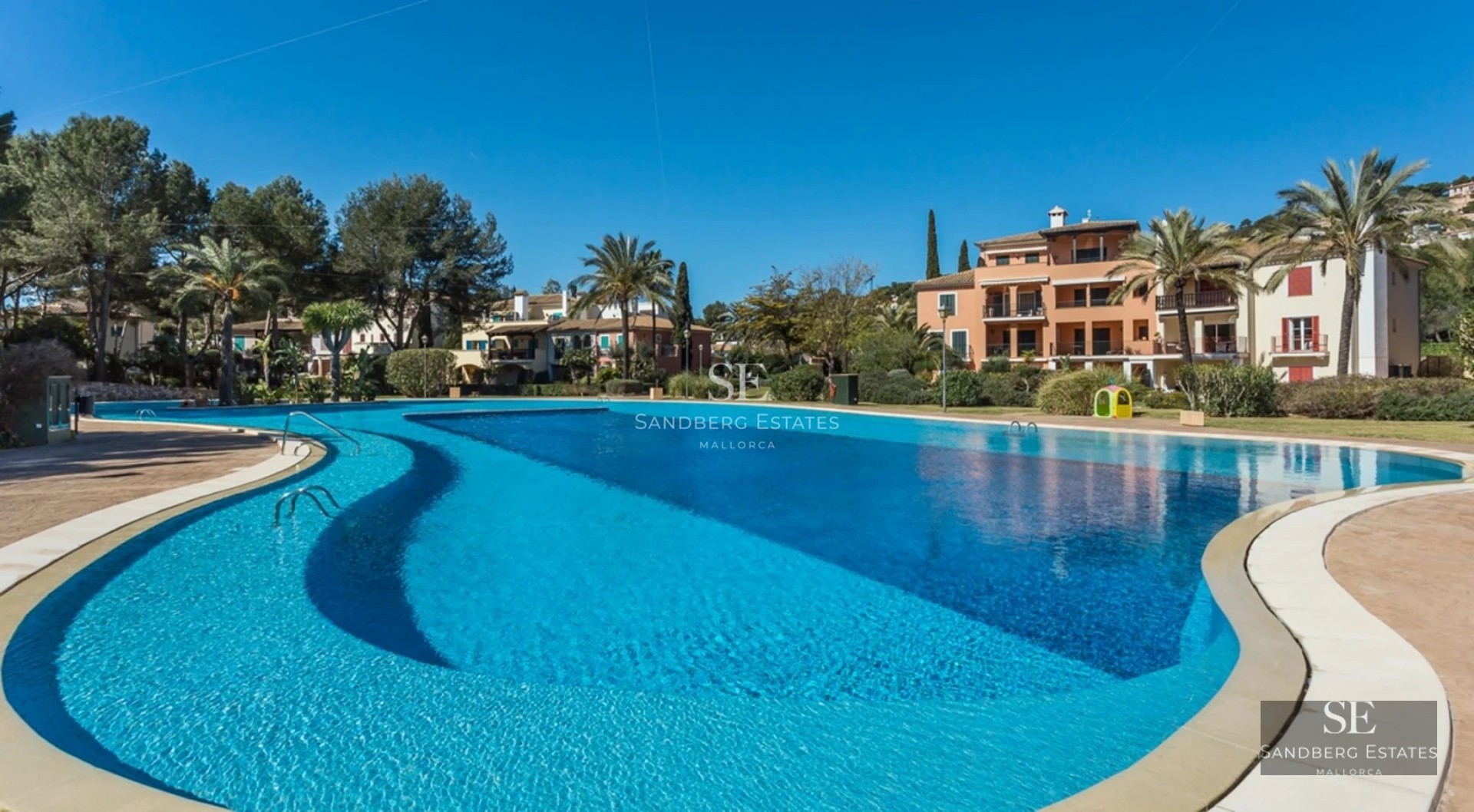 Exterior view of modern villa with pool, lush garden, and minimalist architecture. Ideal for investment and enjoyment.