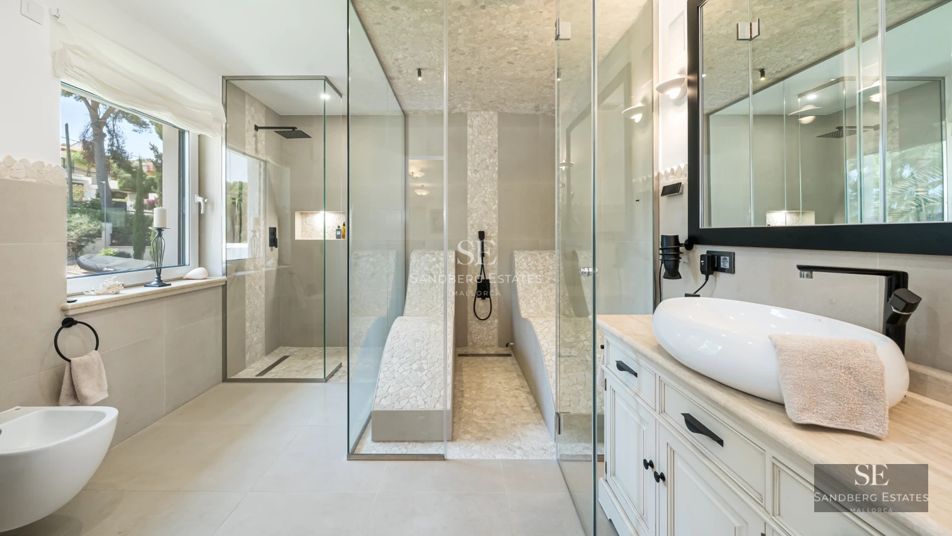 Large balcony with panoramic sea views. Modern design with glass railing and stylish furniture.