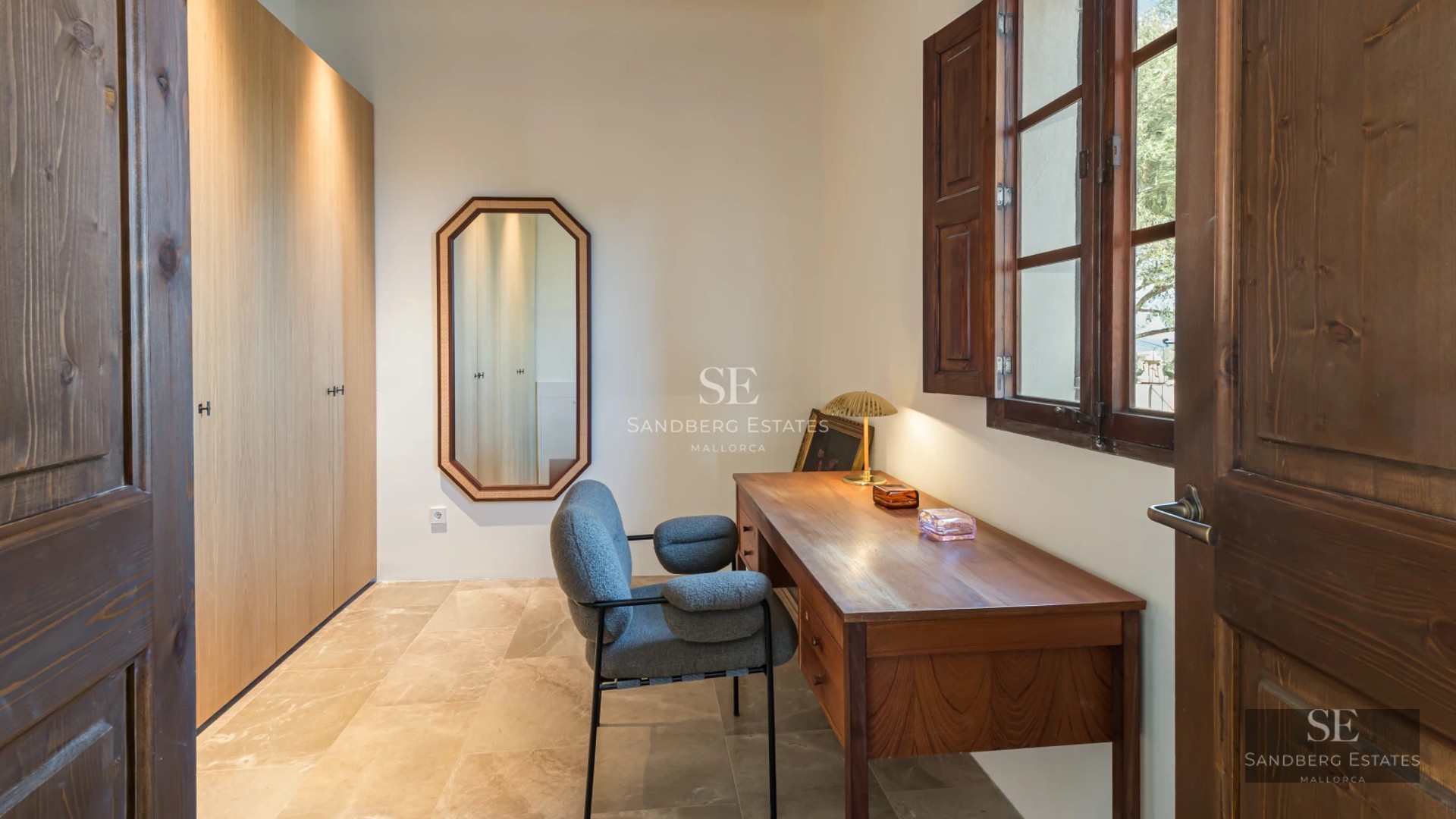 Pool view with wooden deck and armchairs. Modern architecture, natural lighting, lush vegetation and blue sky.
