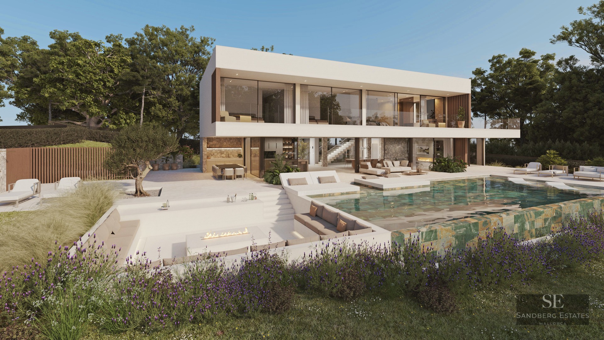 Modern white villa featuring a green stone infinity pool, sunken fire pit seating, and lush landscaping.