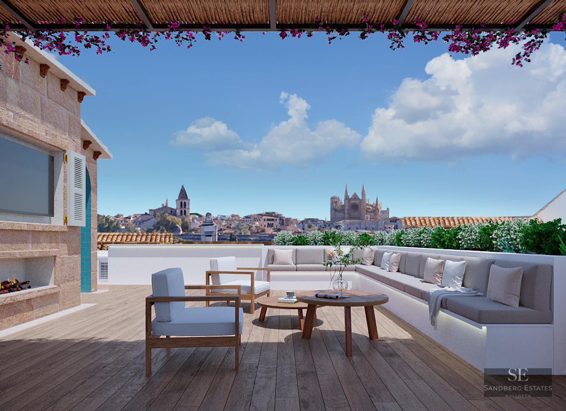 Luxury rooftop terrace with wooden deck, comfortable lounge seating, fireplace, and panoramic views of a city cathedral.