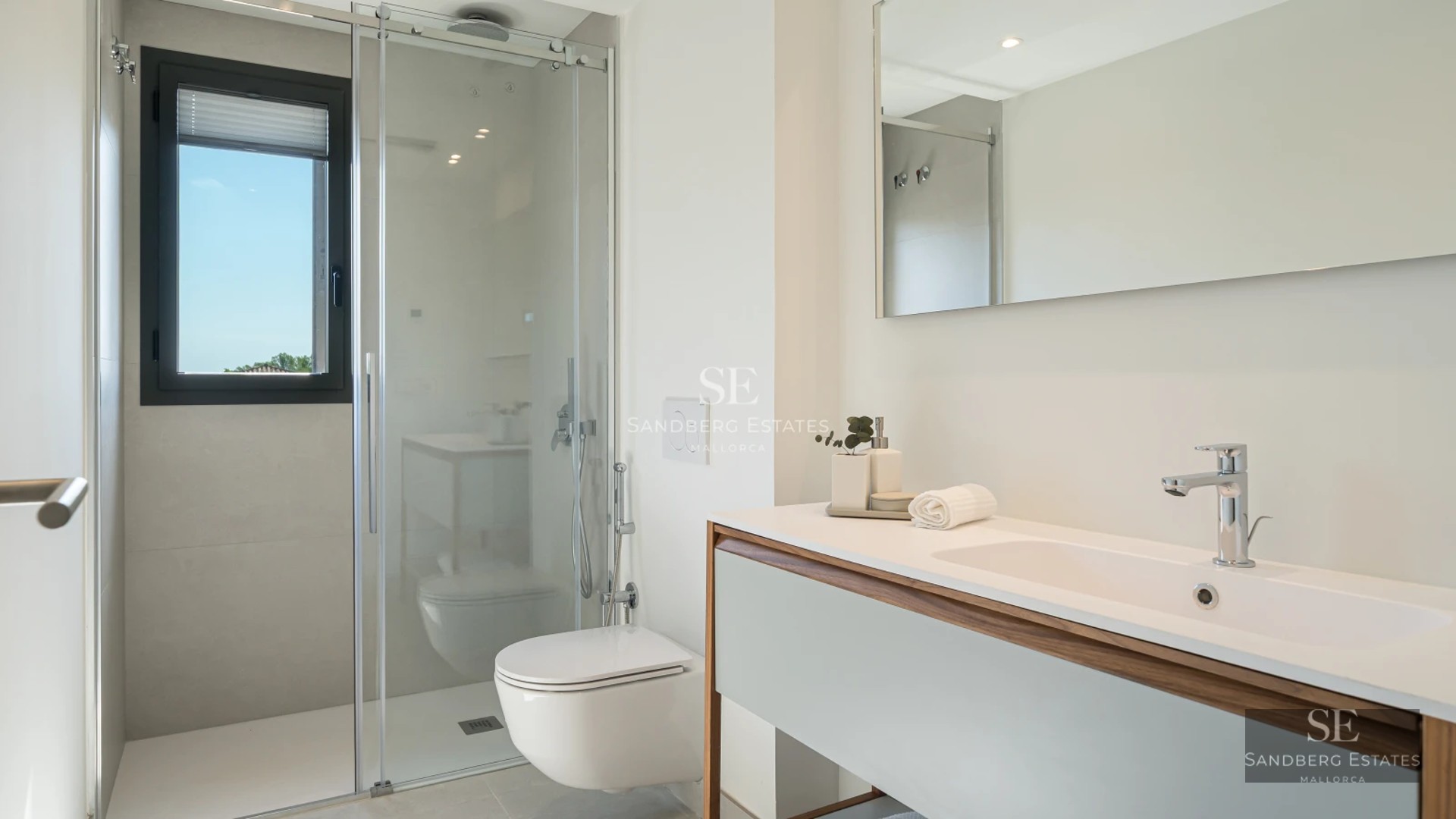 Exterior of modern villa featuring a pool, garden, and large windows maximizing natural light. Minimalist architecture and manicured landscaping.