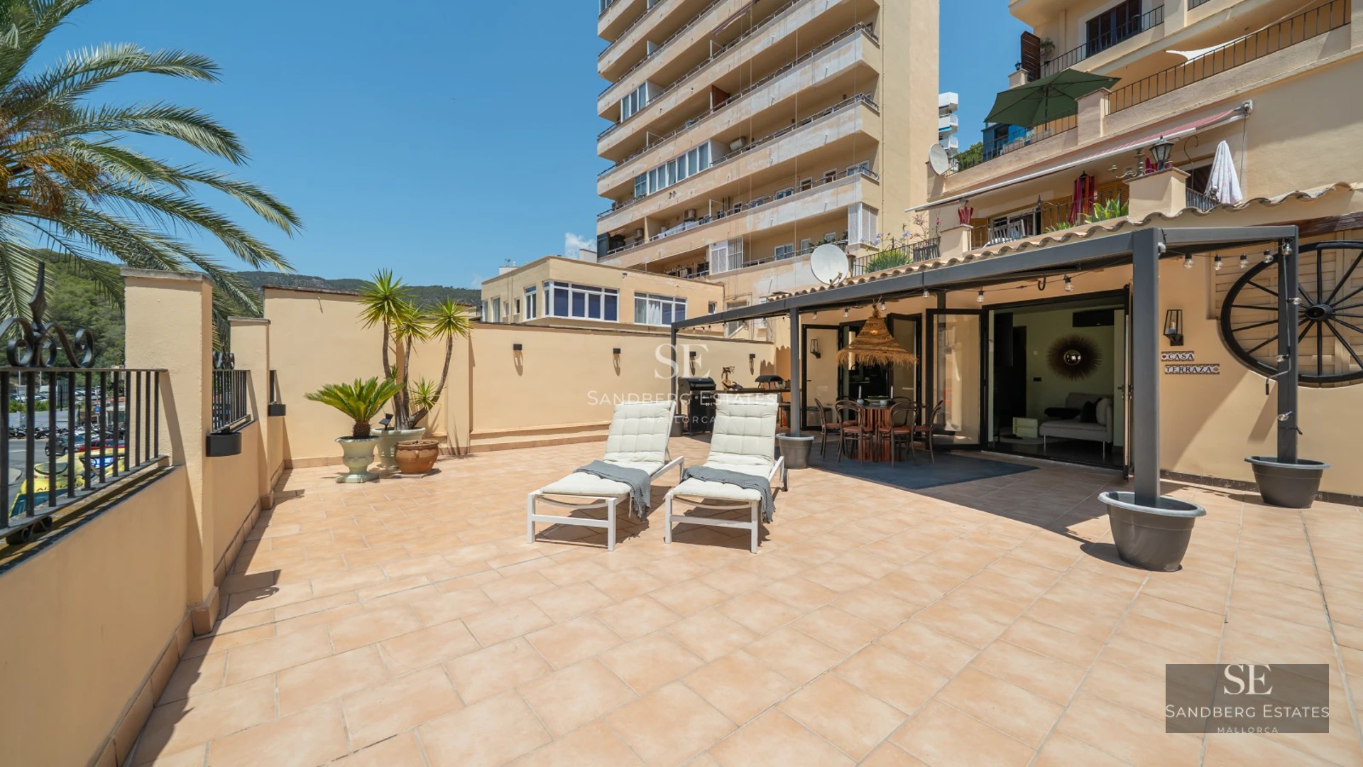 Exterior view of a luxurious villa with infinity pool, lush garden, and modern architecture. Warm sunset lighting.