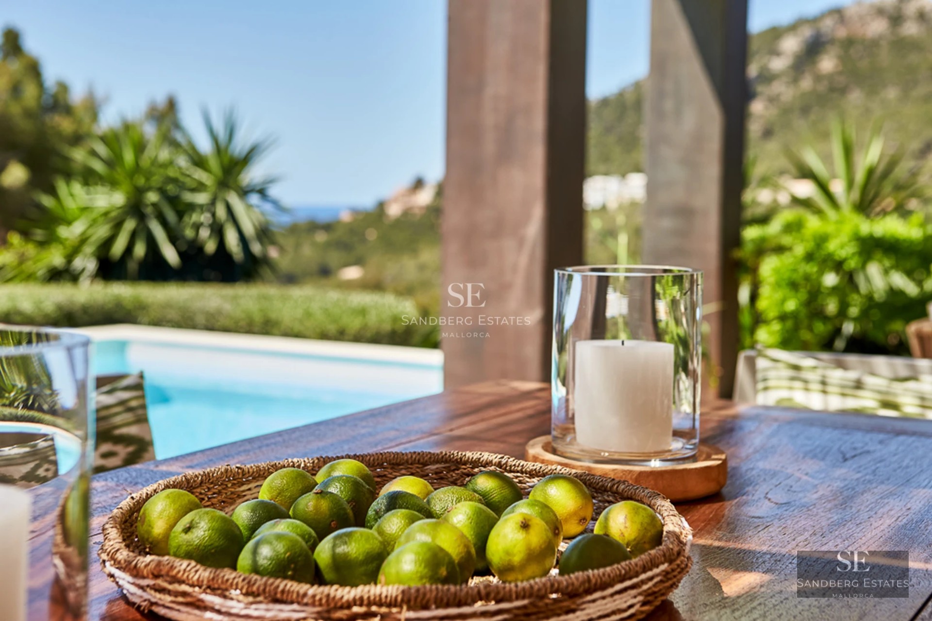 Exterior view of a modern home featuring a swimming pool, minimalist design, large windows, and lush garden. Warm lighting.