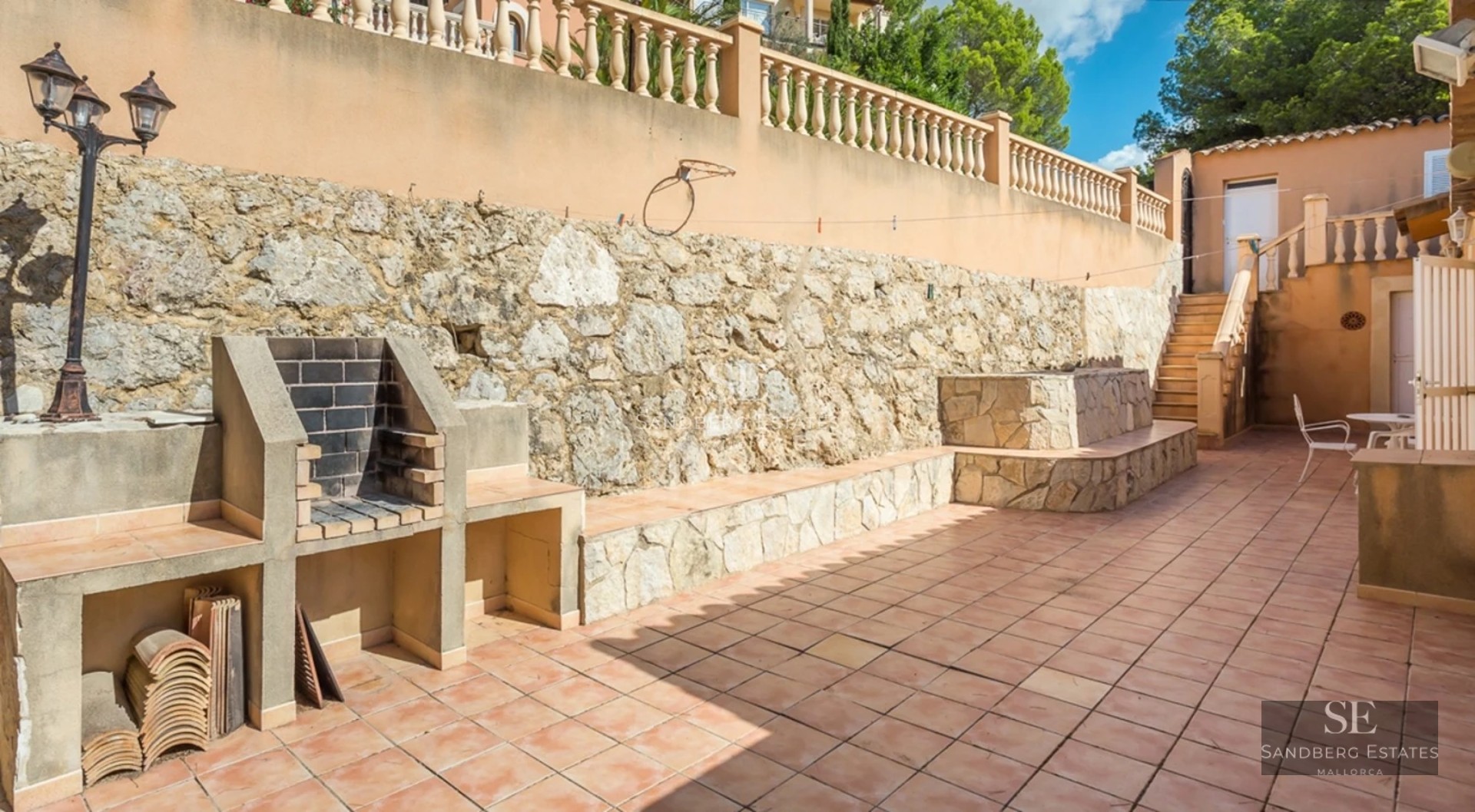Aerial view of a luxurious house with a pool, manicured garden, and modern architectural design. Abundant natural lighting.