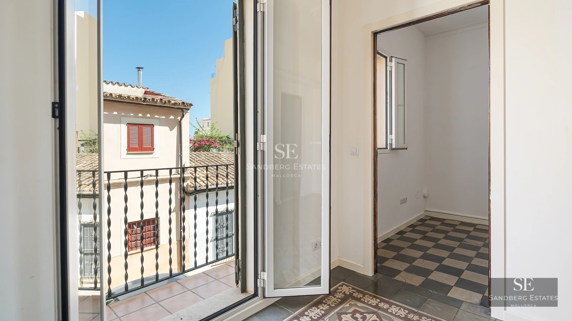 Spacious balcony with sea view. Designer furniture, wooden floor and glass railing. Relaxation and luxury overlooking the ocean.