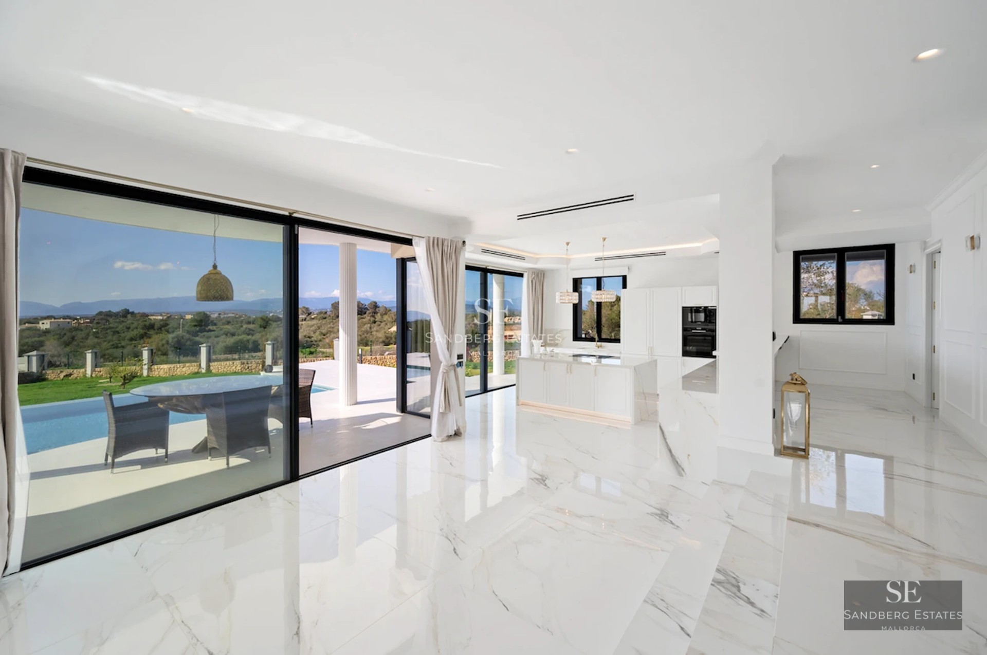 Spacious terrace with infinity pool and sea views. Modern design with stylish furniture and protective awning. Ambient lighting details.