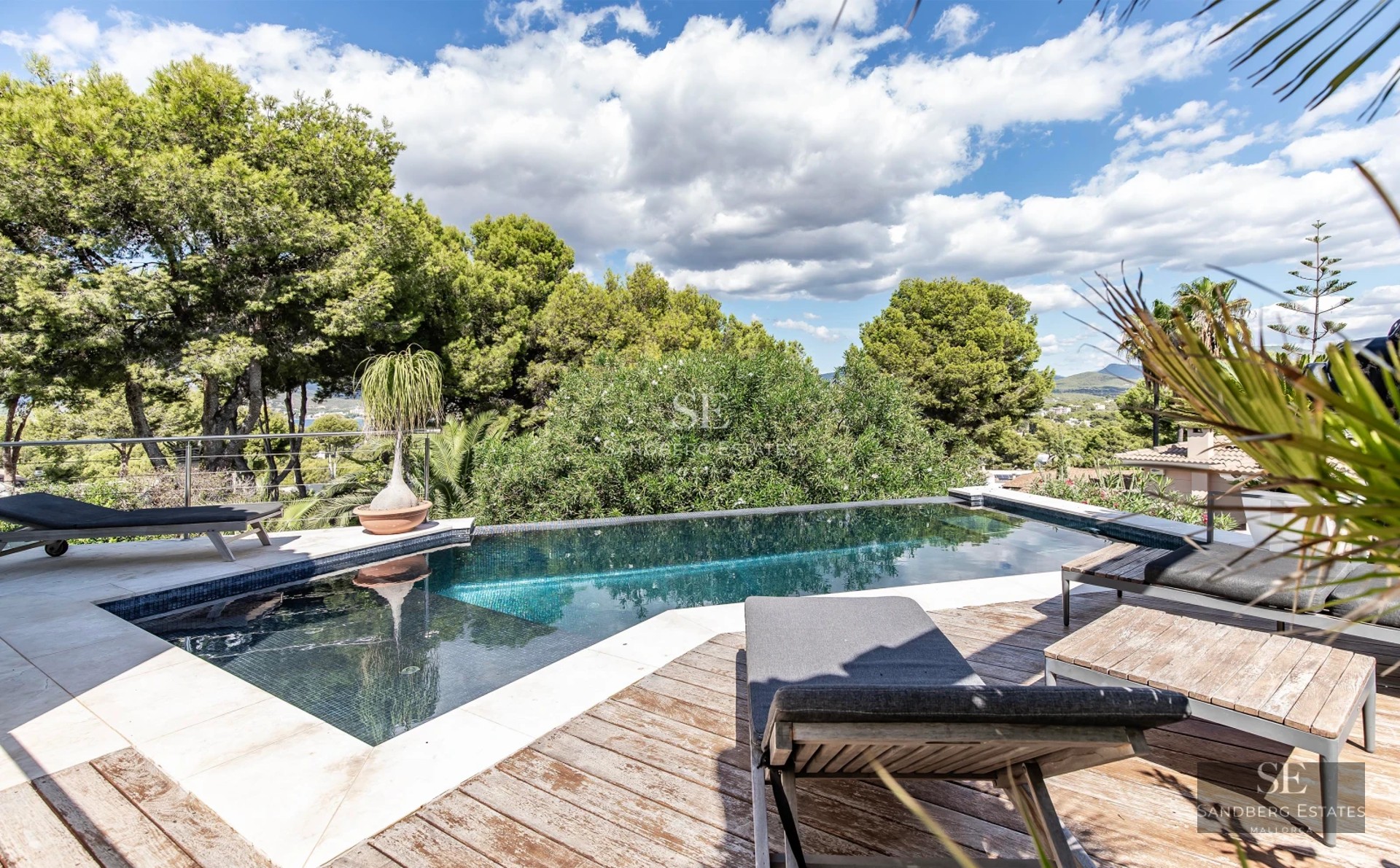 Spacious terrace with pool and panoramic views. Modern architecture, elegant furnishings, and abundant natural light.