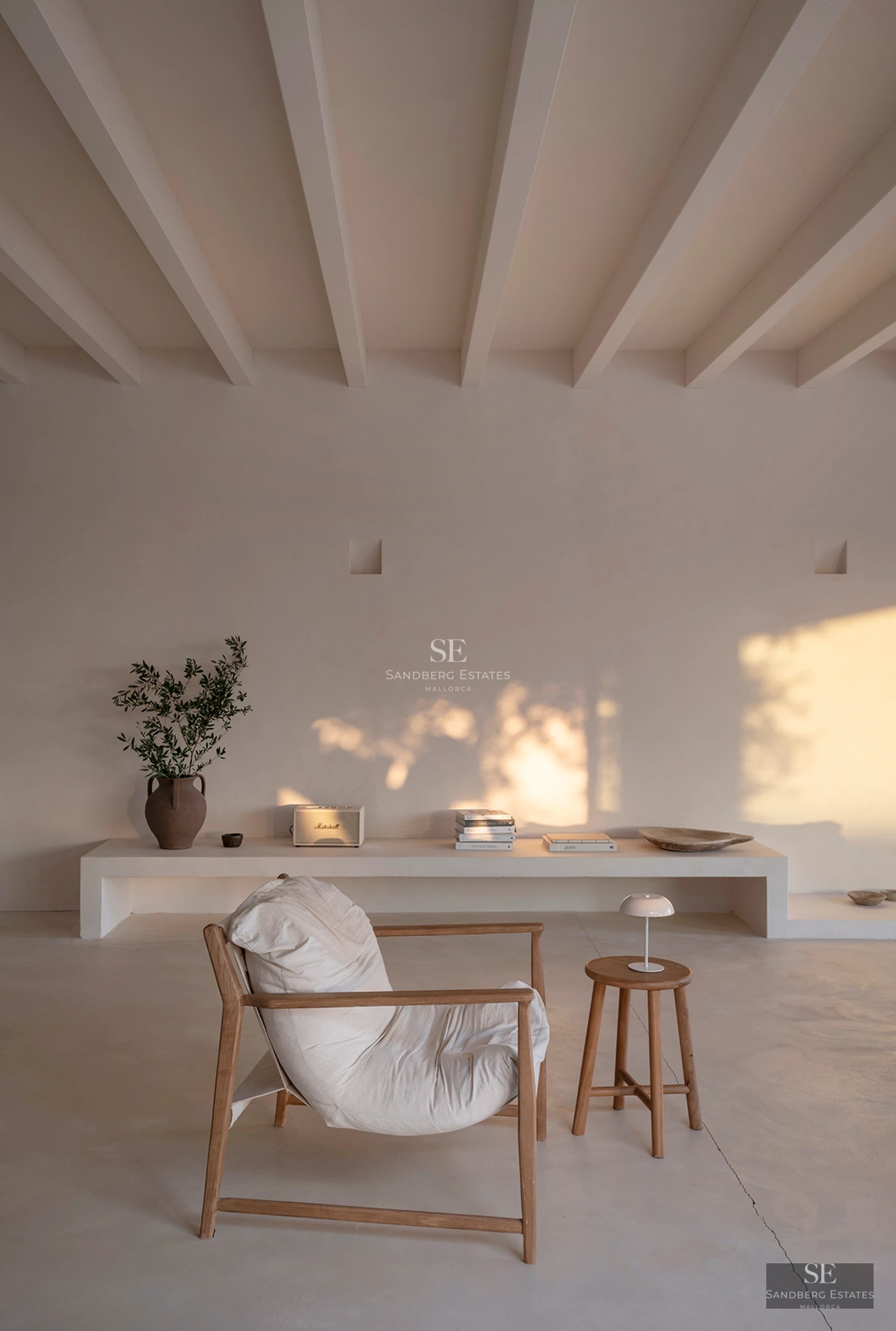 Aerial view of modern villa with reflecting pool, surrounded by lush greenery. Minimalist architecture with clean lines and expansive terraces.