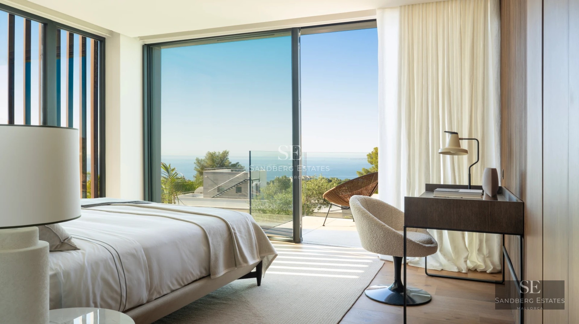 Spacious living room with balcony, panoramic views. Bright, elegant and modern interior. Wood floors, minimalist decor.