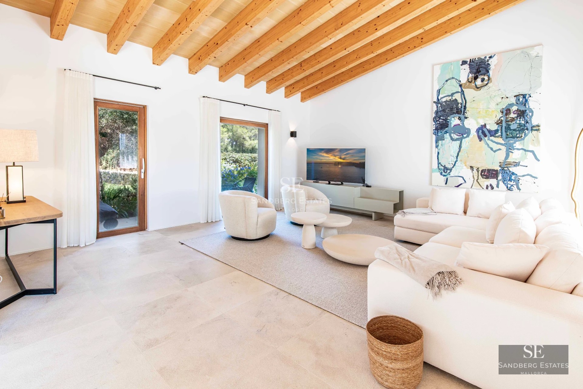 Spacious living room with large windows, designer sofas, stylish coffee table, and panoramic sea views. Bright and modern.