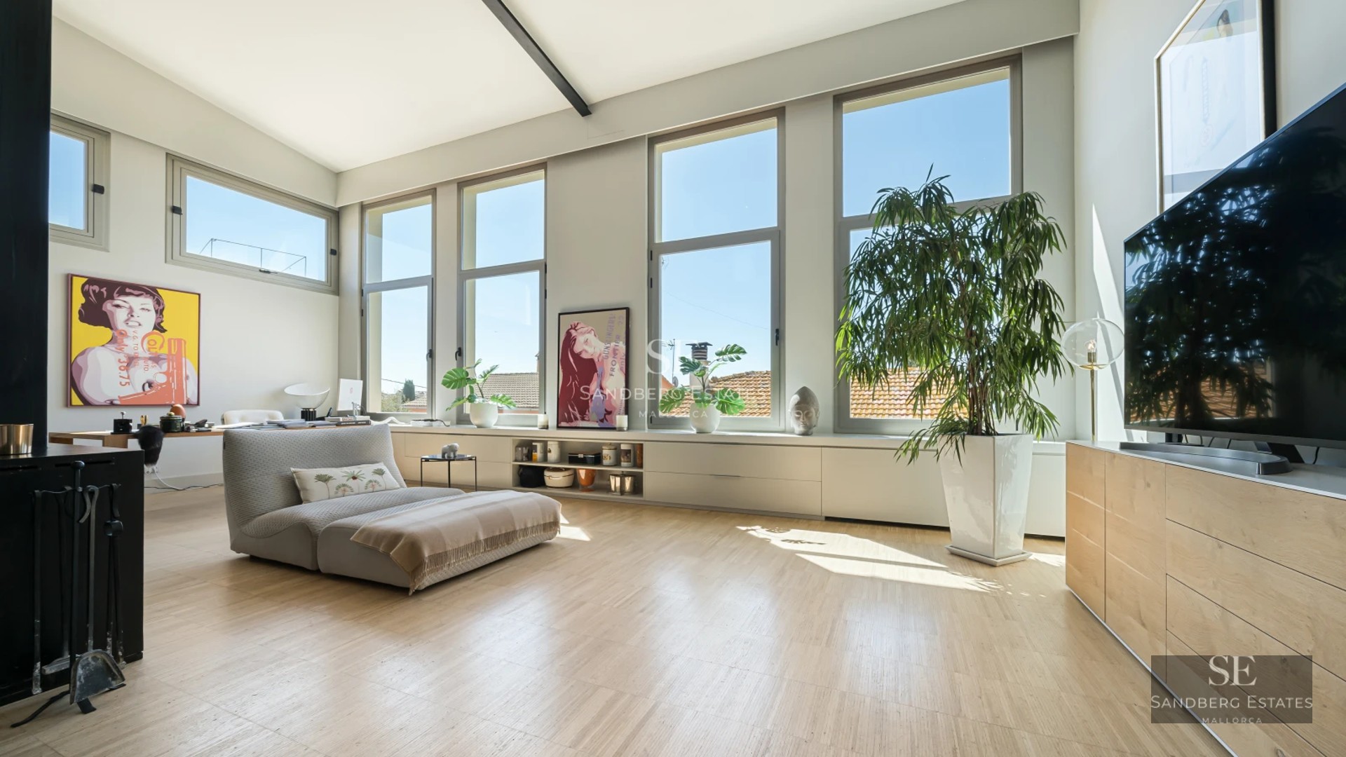 Spacious terrace with panoramic sea views, modern furniture, glass railing, wooden floor. Luxurious and relaxing atmosphere.