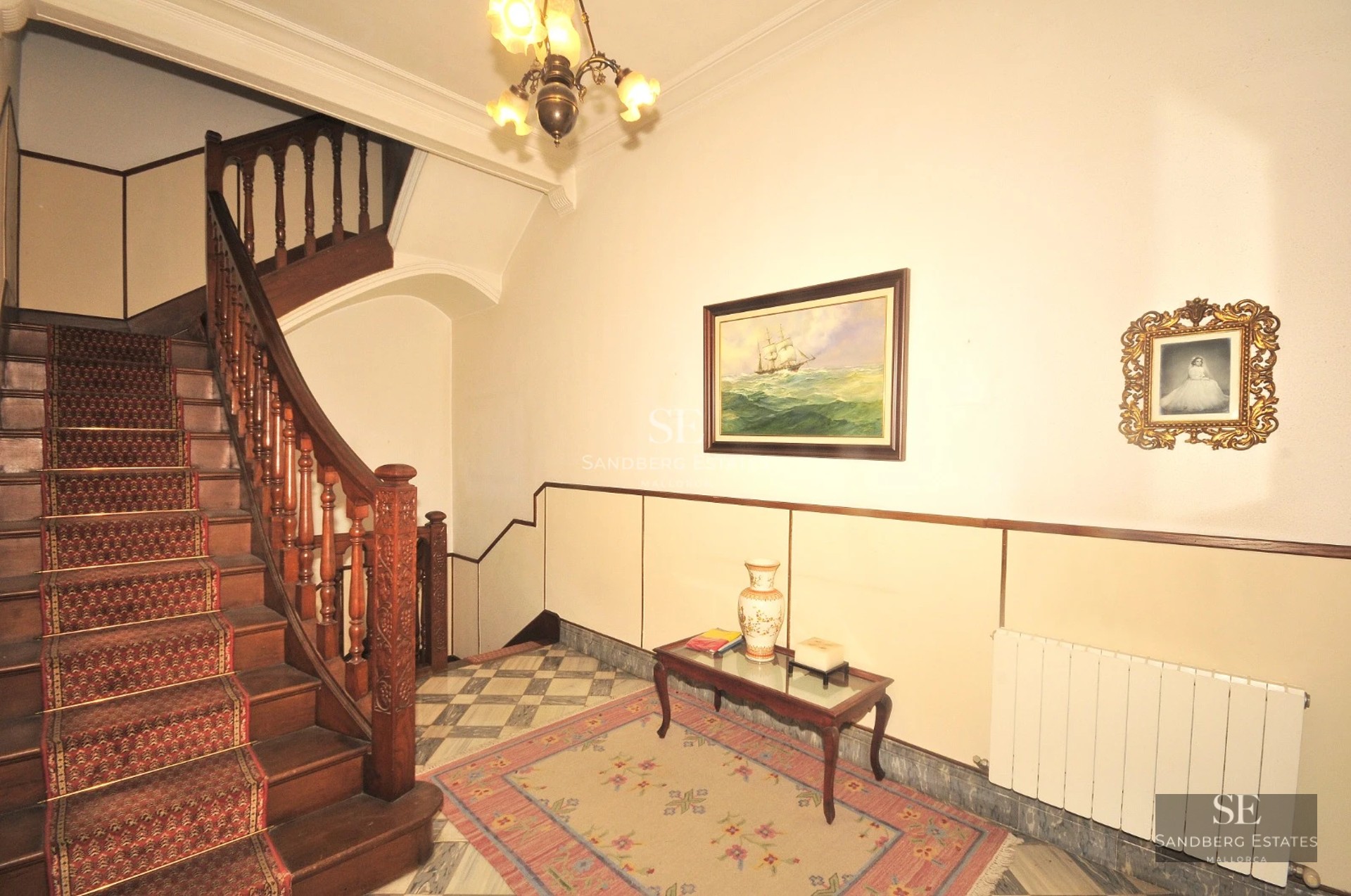 Spacious living room with floor-to-ceiling windows, light wood floor, modern fireplace, and garden view. Minimalist design and natural light.