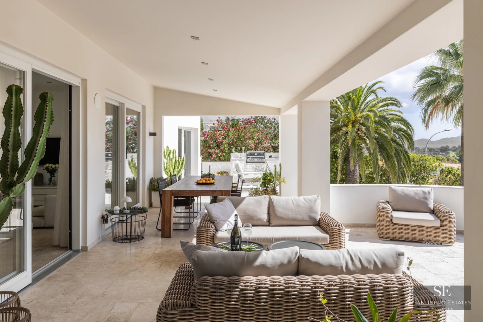 Spacious living room with fireplace, large windows and panoramic sea views. Modern and bright decor, designer furniture.