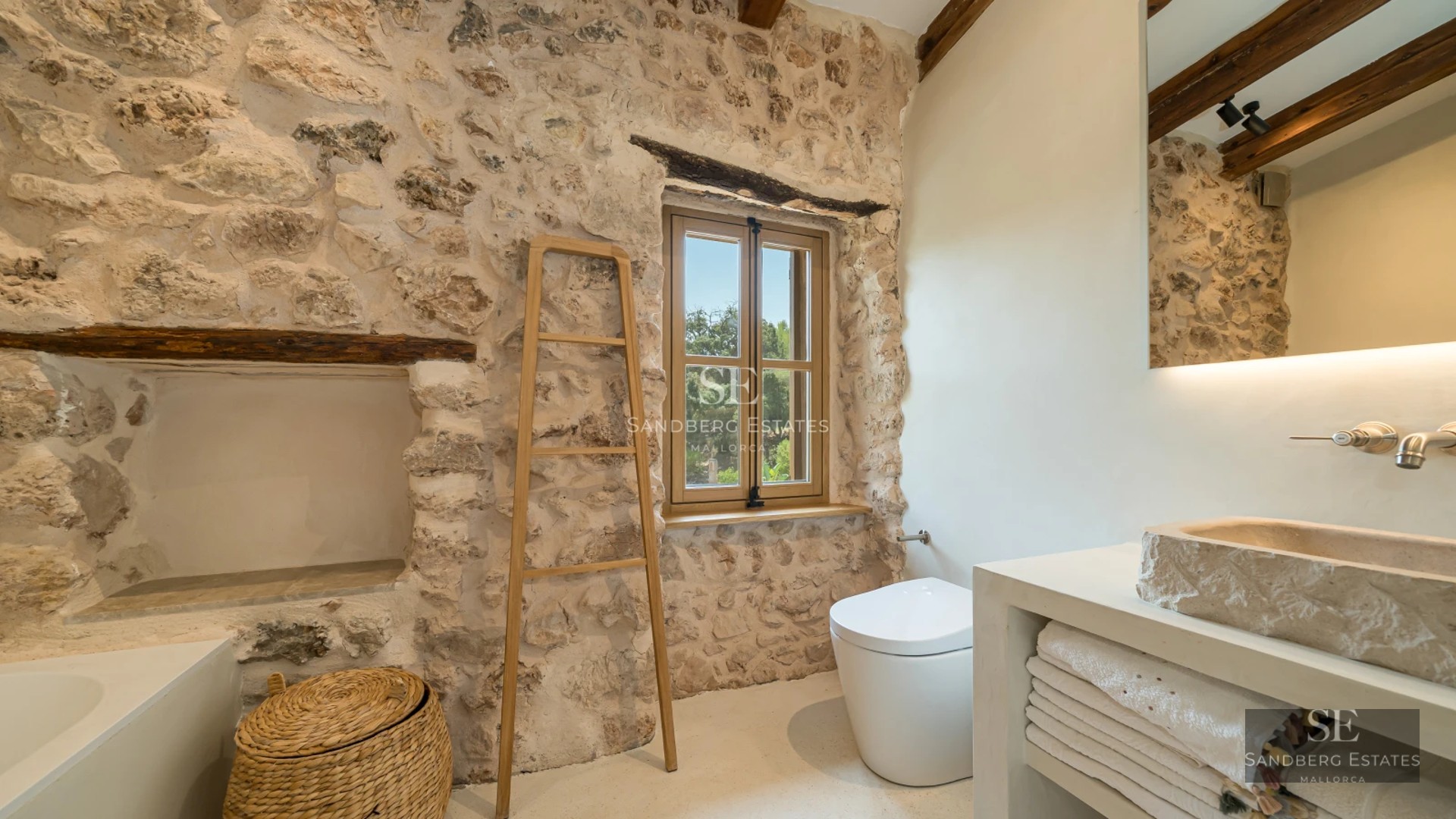 Exterior view of a modern villa with a pool, lush garden, and elegant architecture. White facade, large windows, and manicured landscaping.