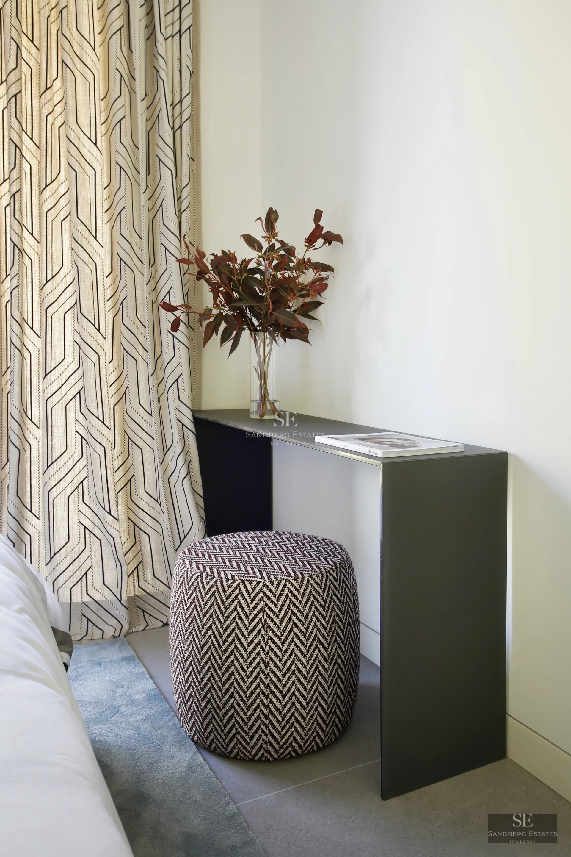 Aerial view of a modern villa with infinity pool, surrounded by lush gardens and panoramic views. Minimalist architecture and high-end finishes.