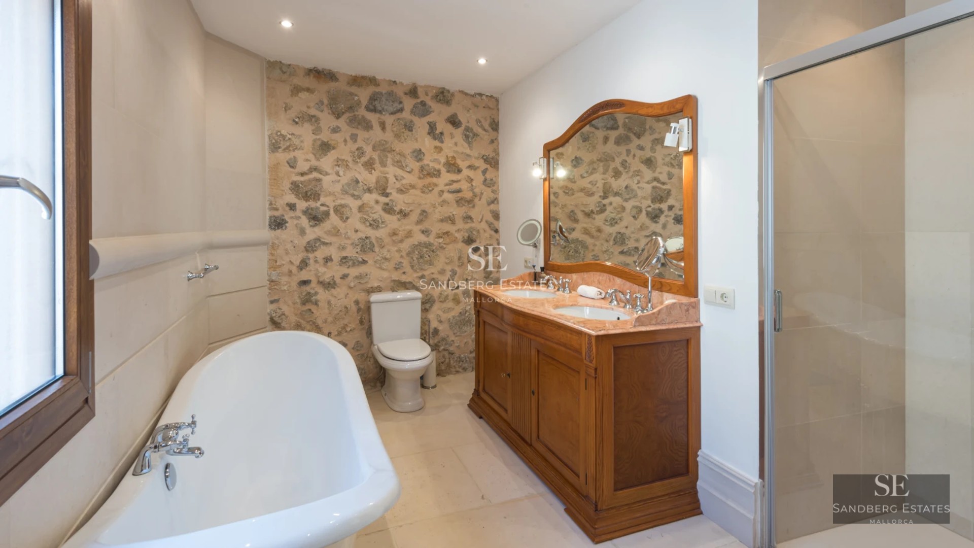 Spacious living room with large windows, city view, light wood floors and modern furniture. Abundant natural light.