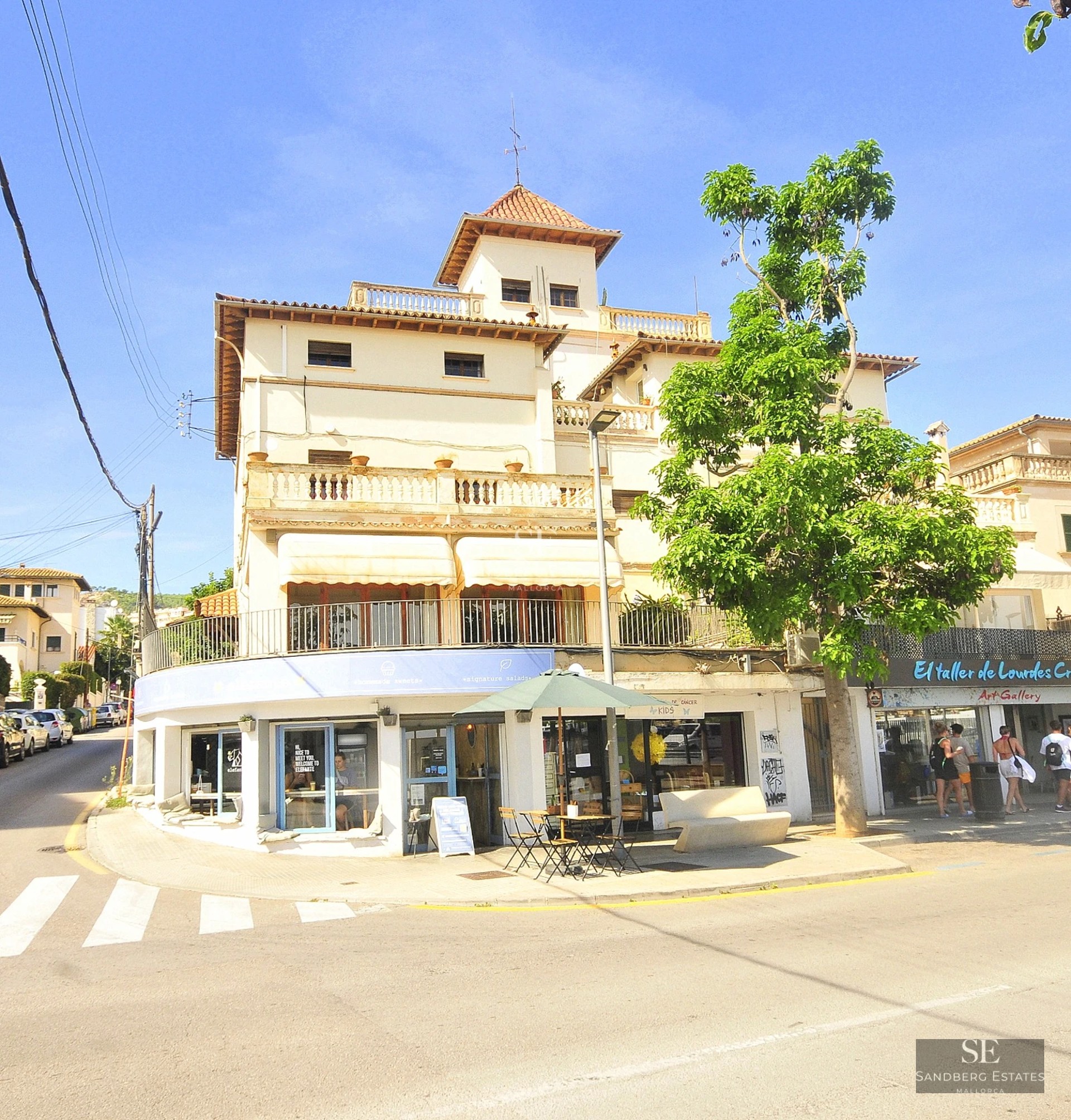 Bright living room with large windows, light wood floors, and modern furniture. Panoramic views and minimalist decor.