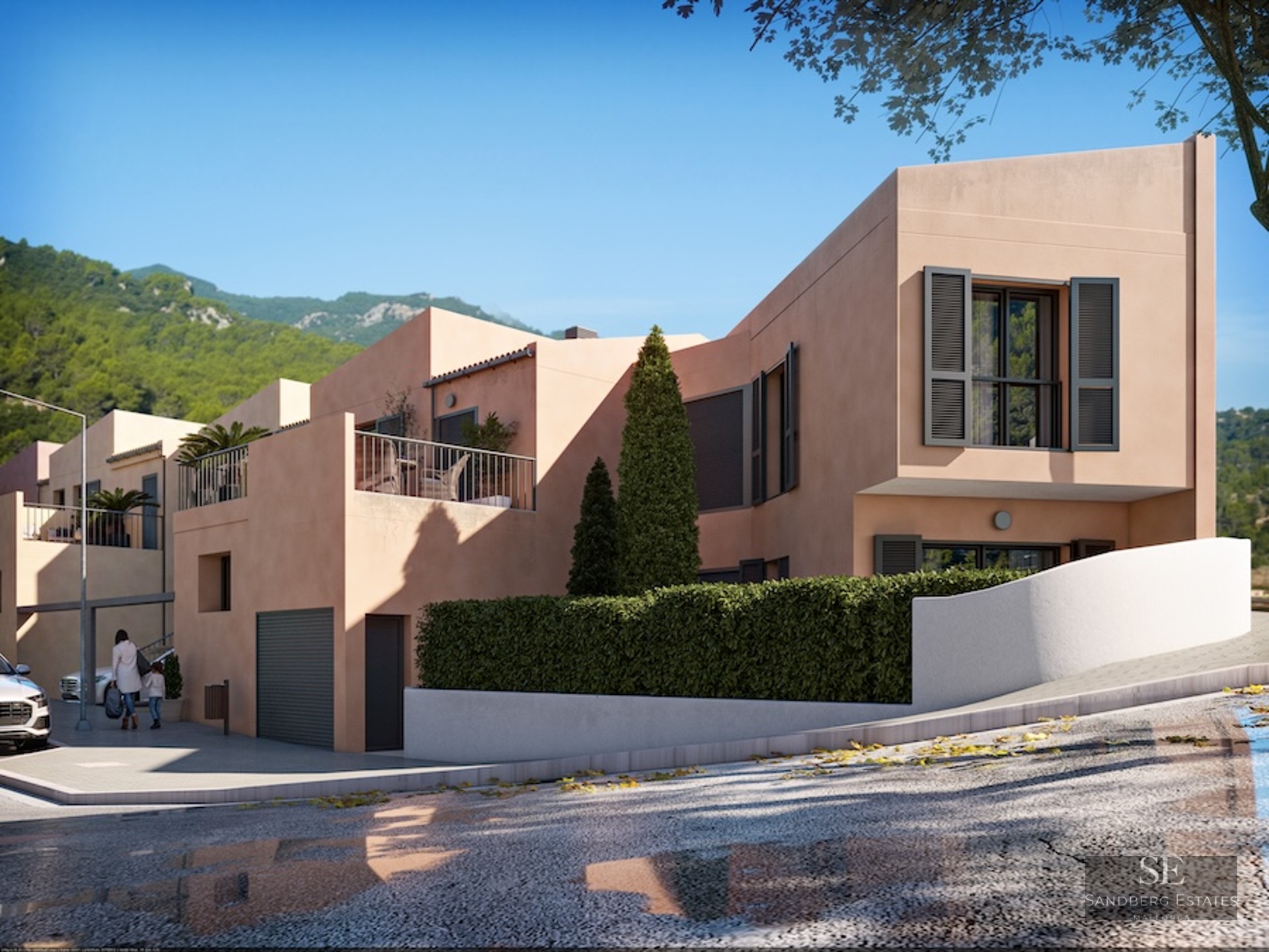 Modern peach-colored villa with dark shutters, terrace, and lush greenery against a mountainous background.